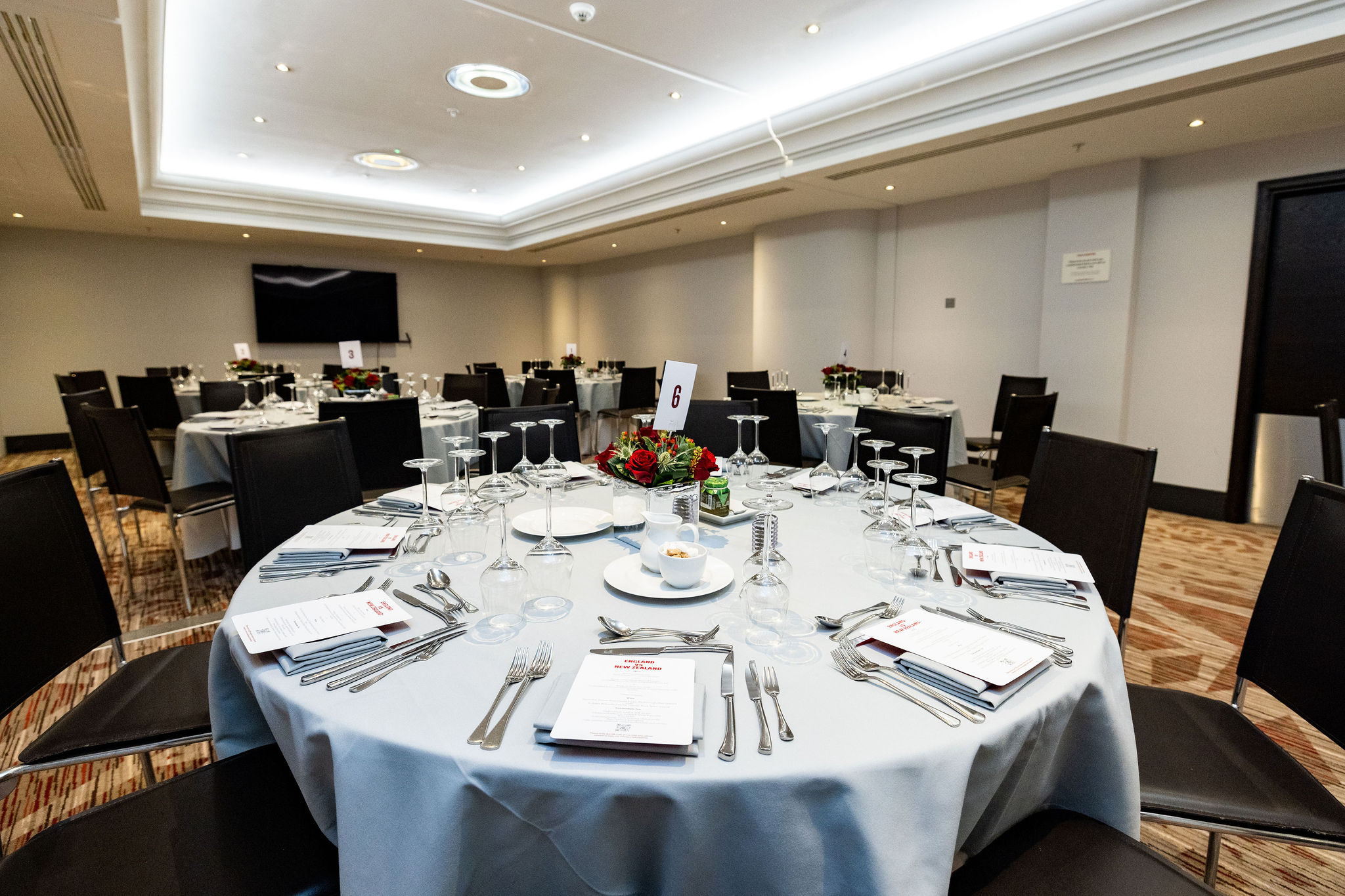 Elegant dinner setup with round tables at Allianz Stadium, perfect for corporate events.