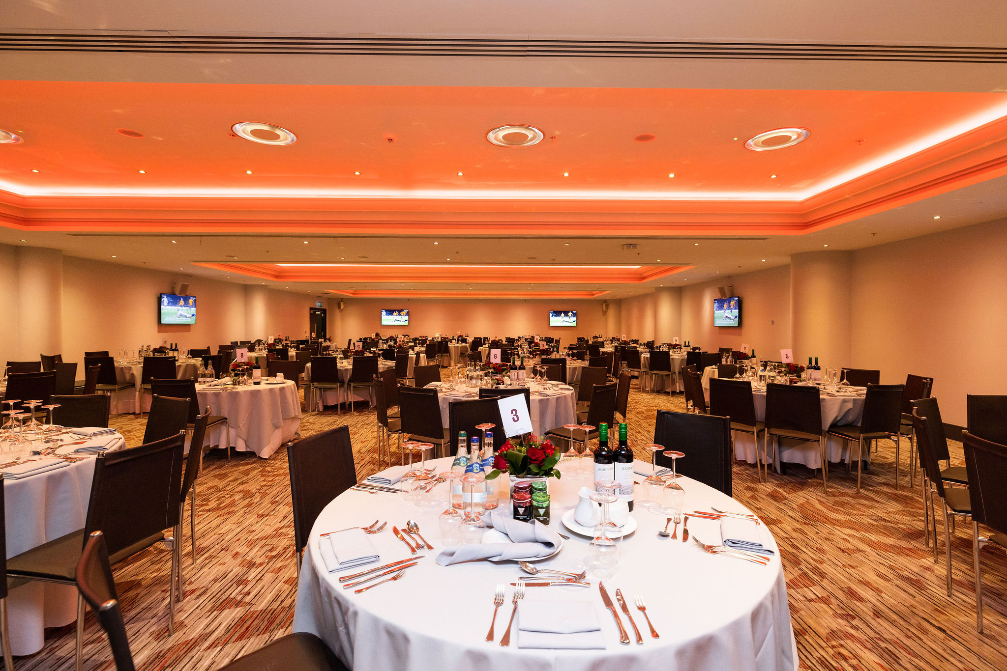 Churchill Suite at Allianz Stadium: elegant event space with round tables for networking or dining.