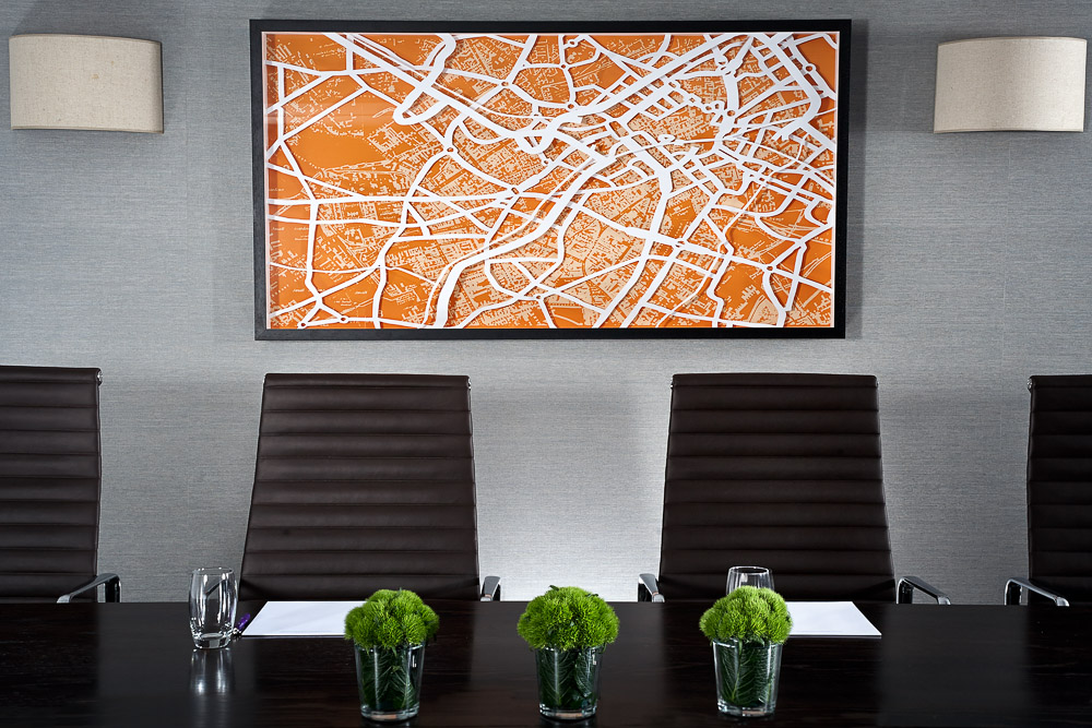 Modern boardroom at Hyatt Regency Birmingham with stylish chairs and vibrant artwork.