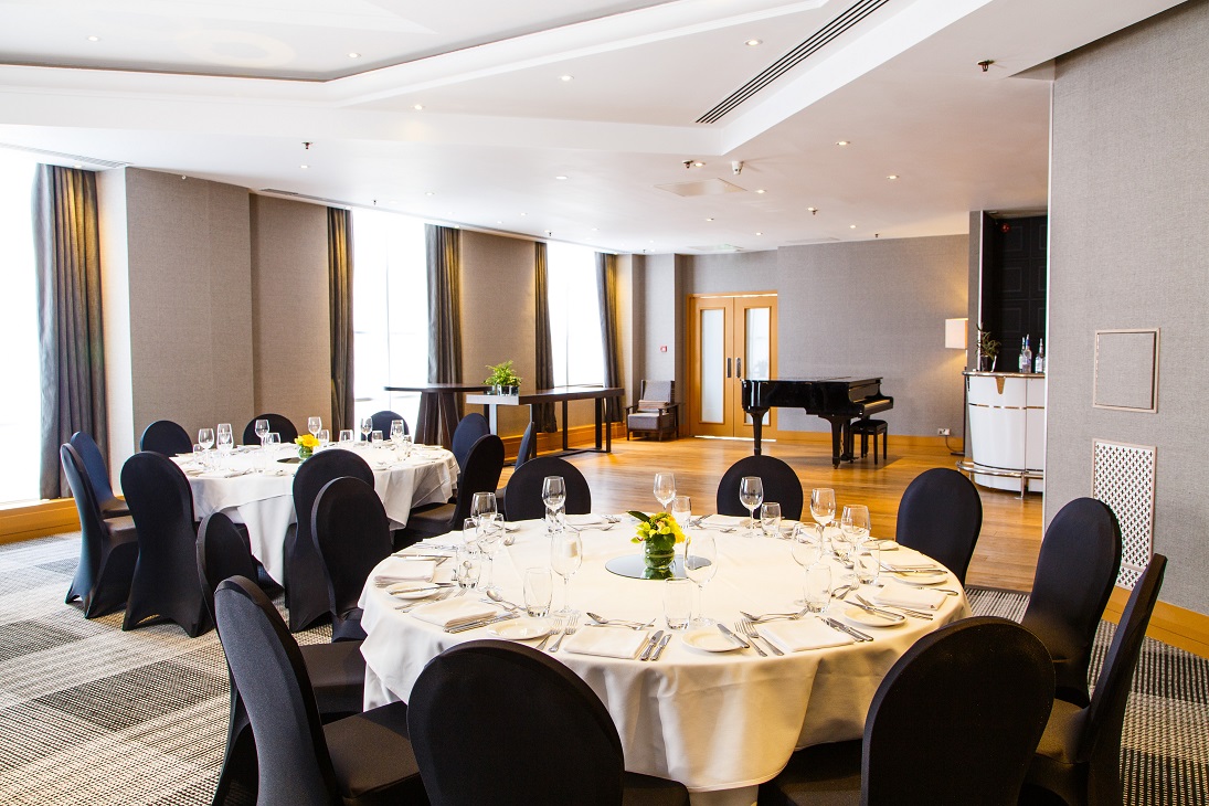 Sonata Suite at Hyatt Regency Birmingham, elegant dinner setup with grand piano.