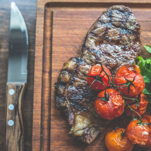 Plated steak with grilled tomatoes at Main Bar & Lounge, St Bart's event catering.