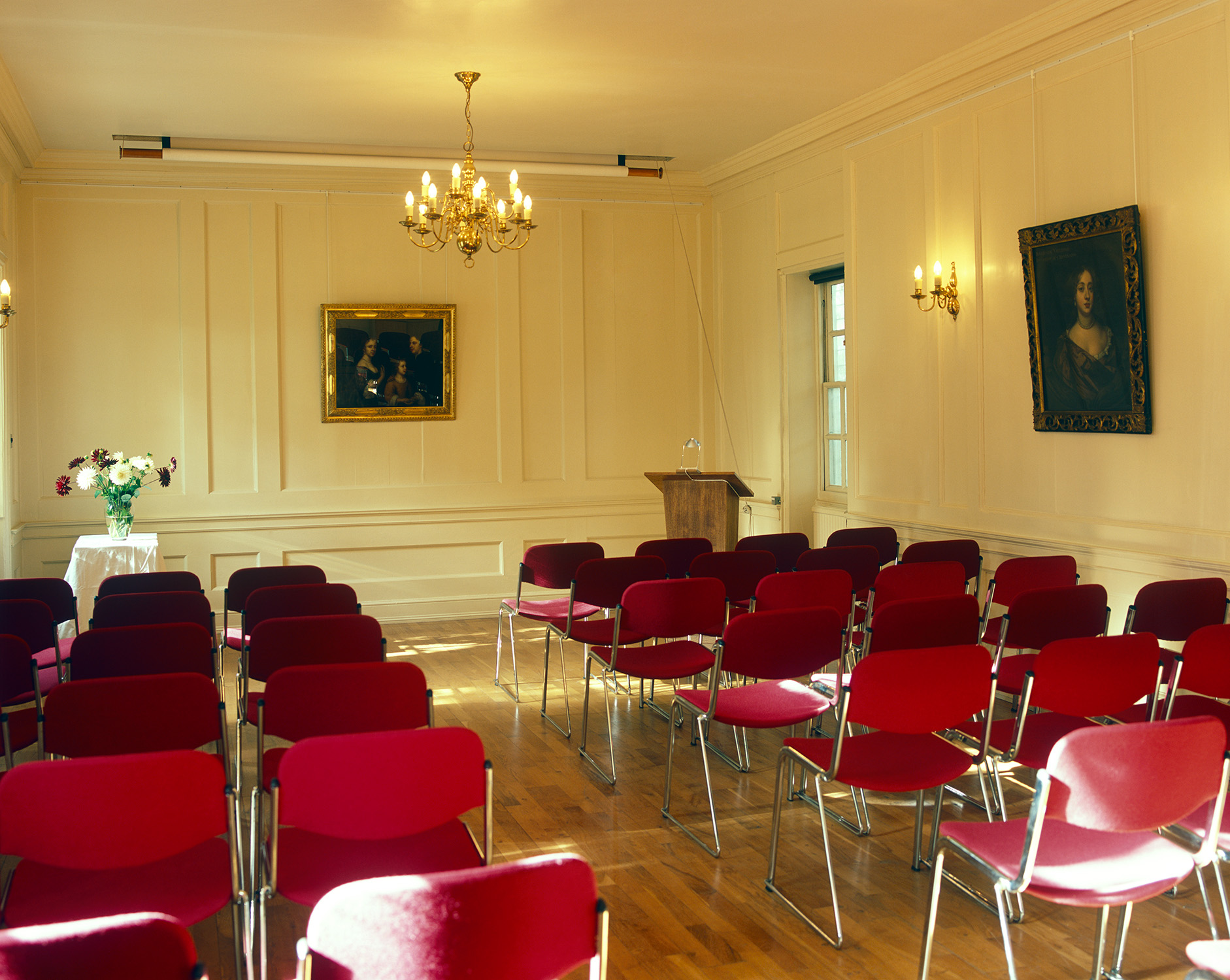 Elegant Georgian Room with red chairs, ideal for meetings and presentations.