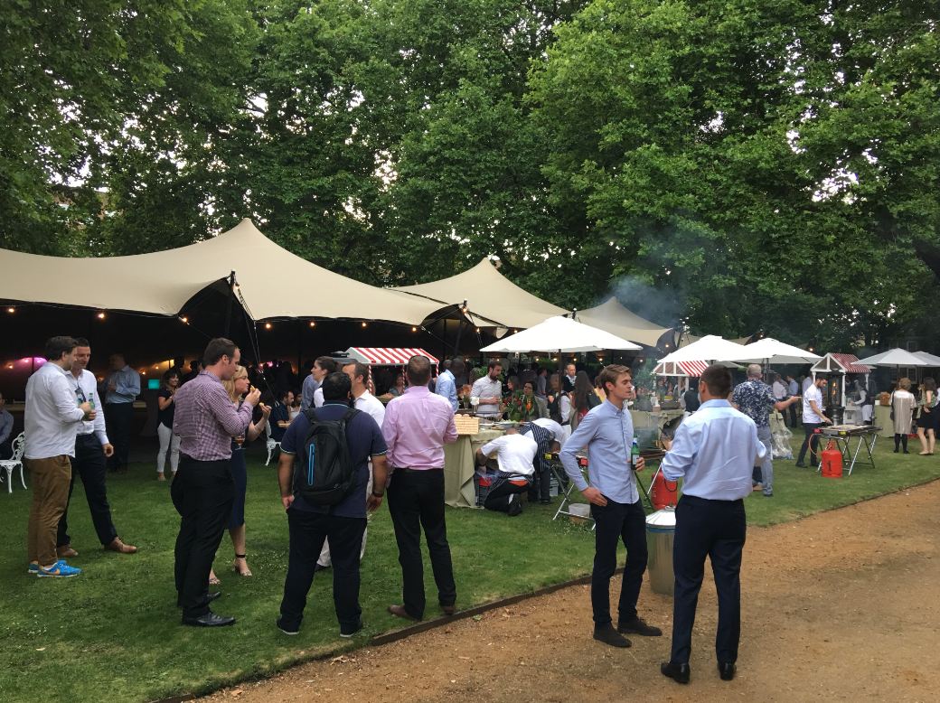 Vibrant outdoor event at The Museum of the Home with tent and food stalls.