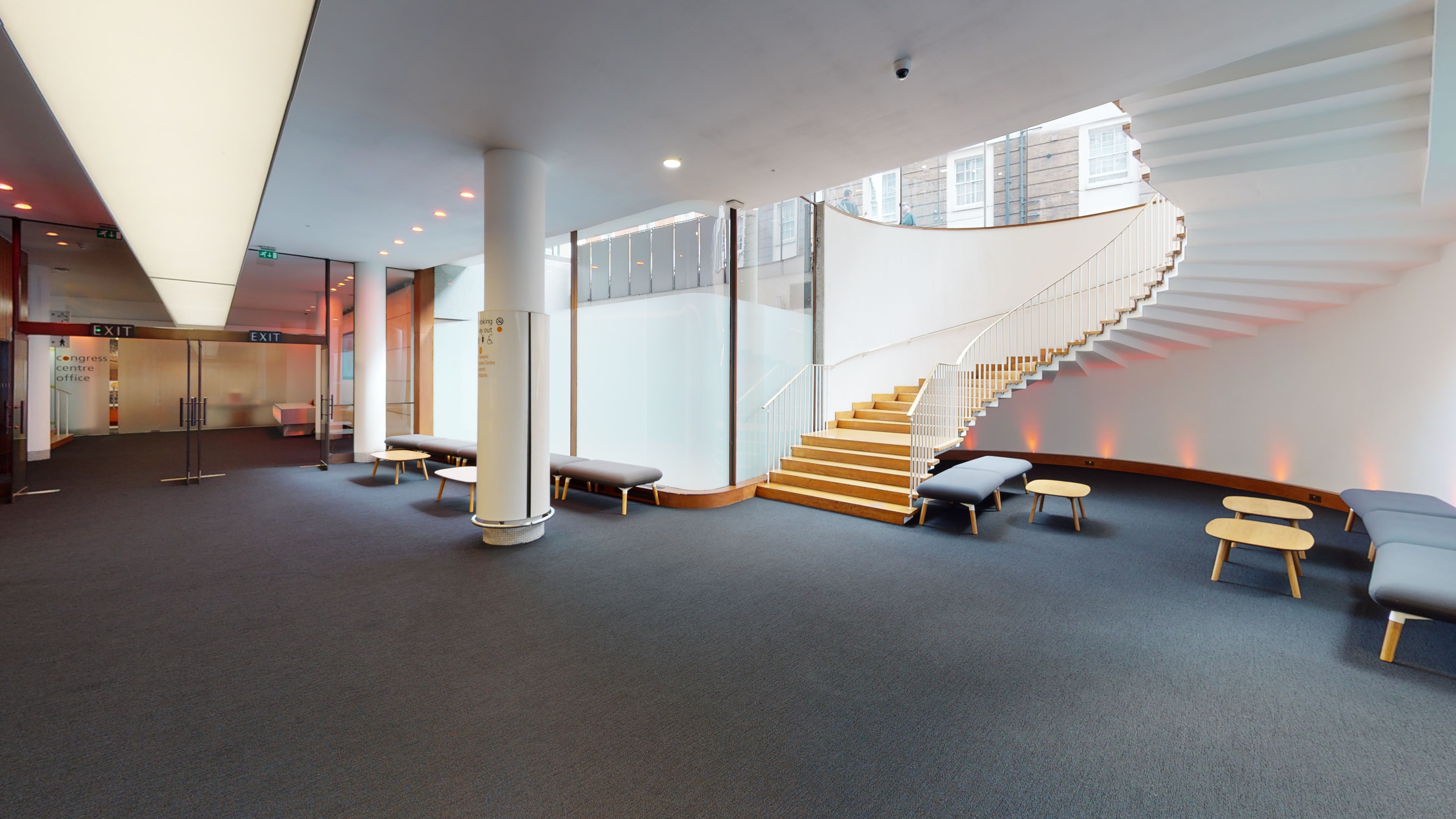 Modern Congress Centre foyer with sleek staircase, ideal for networking events and workshops.