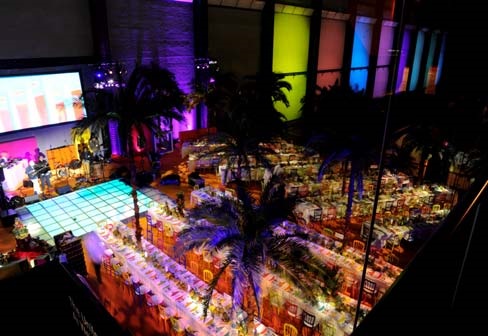 Turbine Hall at Tate Modern, vibrant event space with elegant dining and tropical decor.