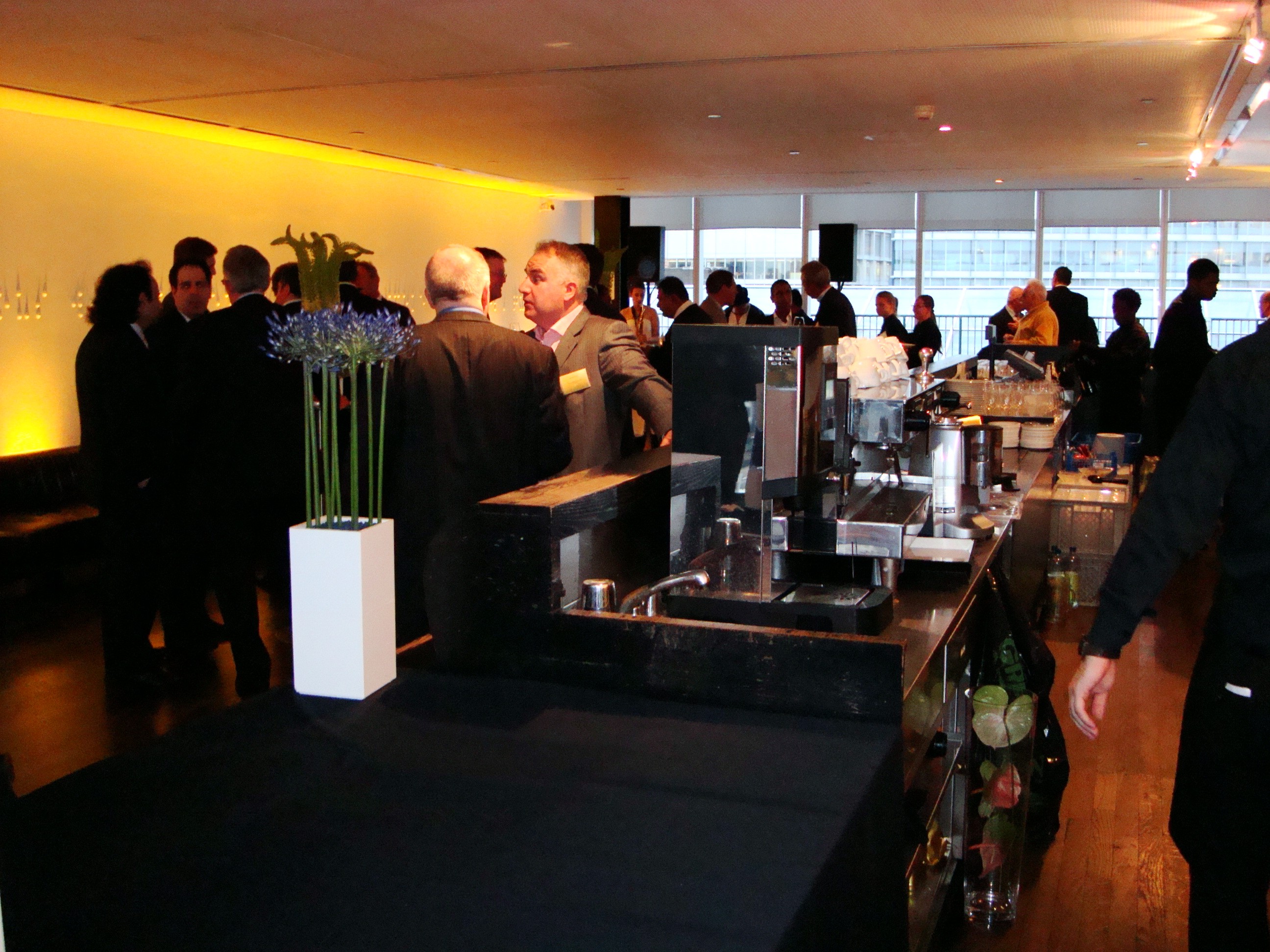 Networking event in Boiler House Members Room, Tate Modern with elegant floral arrangements.