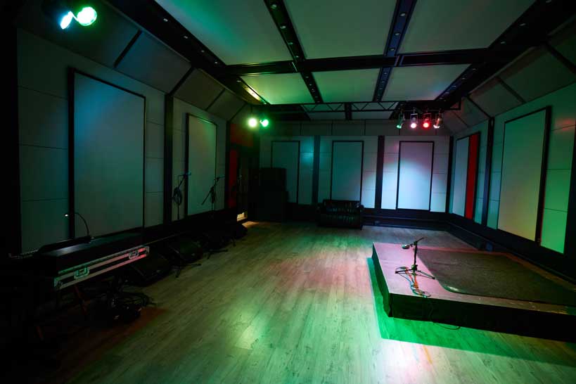 Rehearsal studio in London with stage and lighting for events and performances.