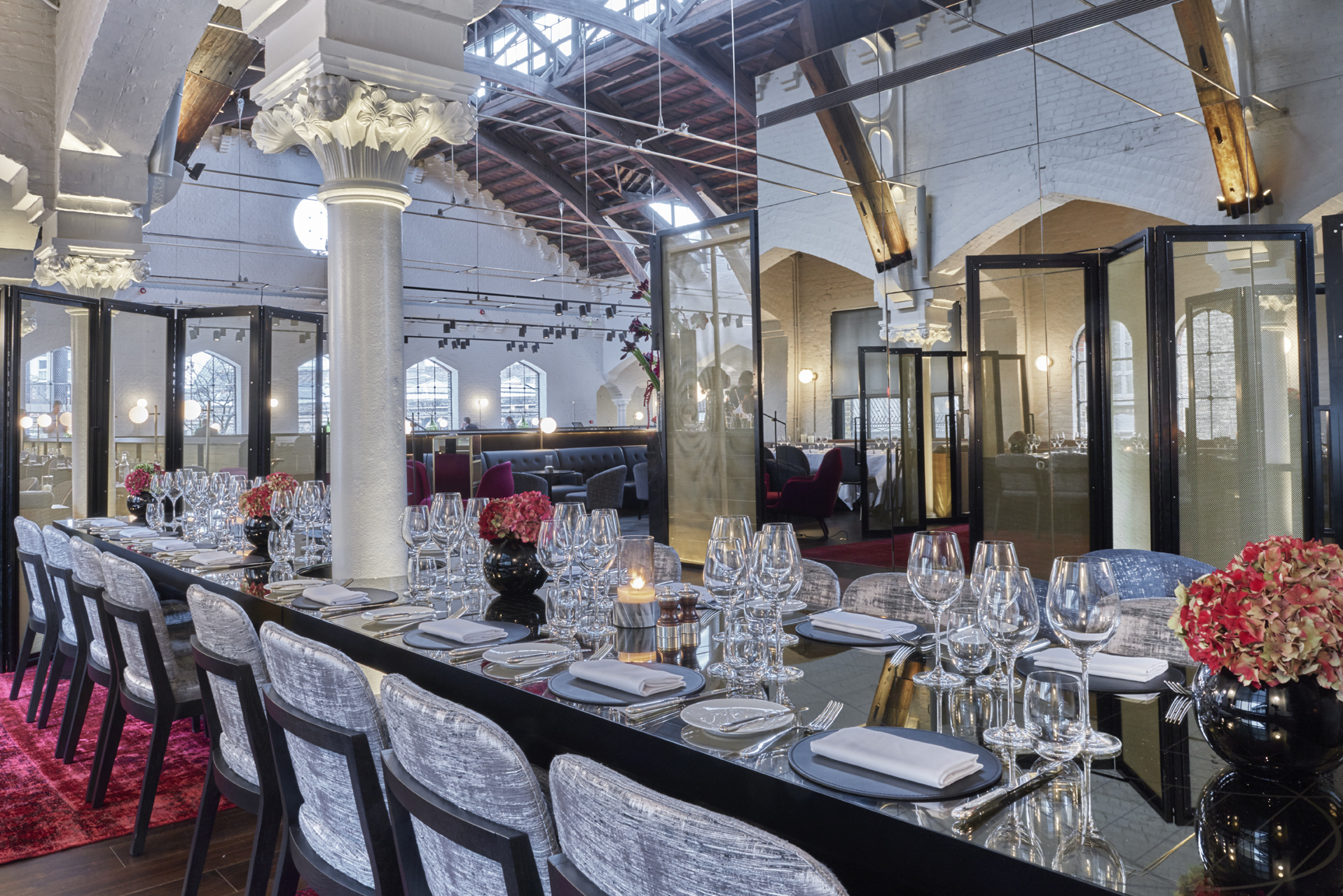 Semi-private event space in German Gymnasium with elegant dining setup for upscale dinners.