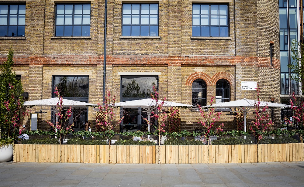 Charming outdoor venue at German Gymnasium with modern canopies for events and gatherings.