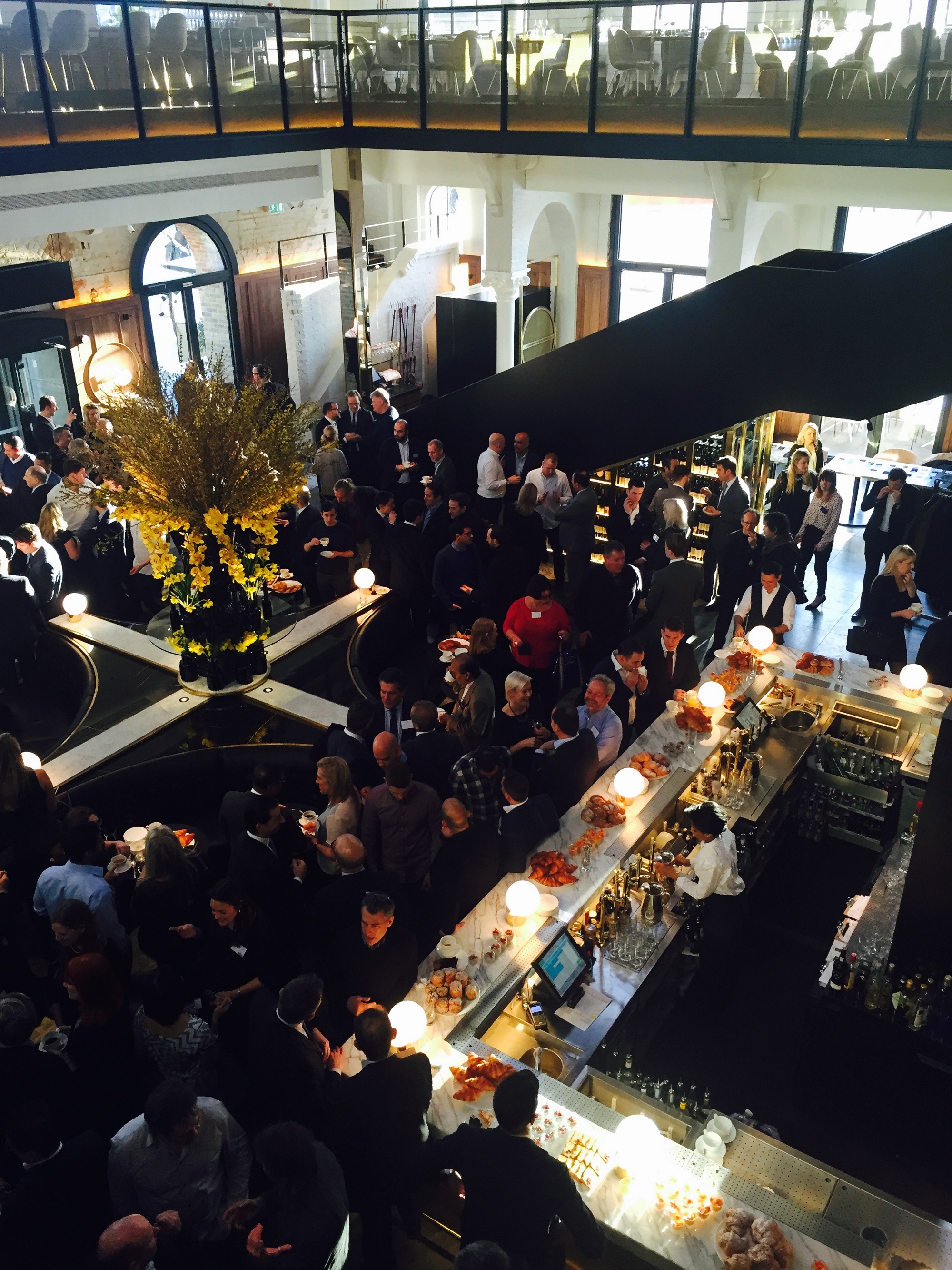 Networking event at German Gymnasium with elegant decor and vibrant atmosphere.