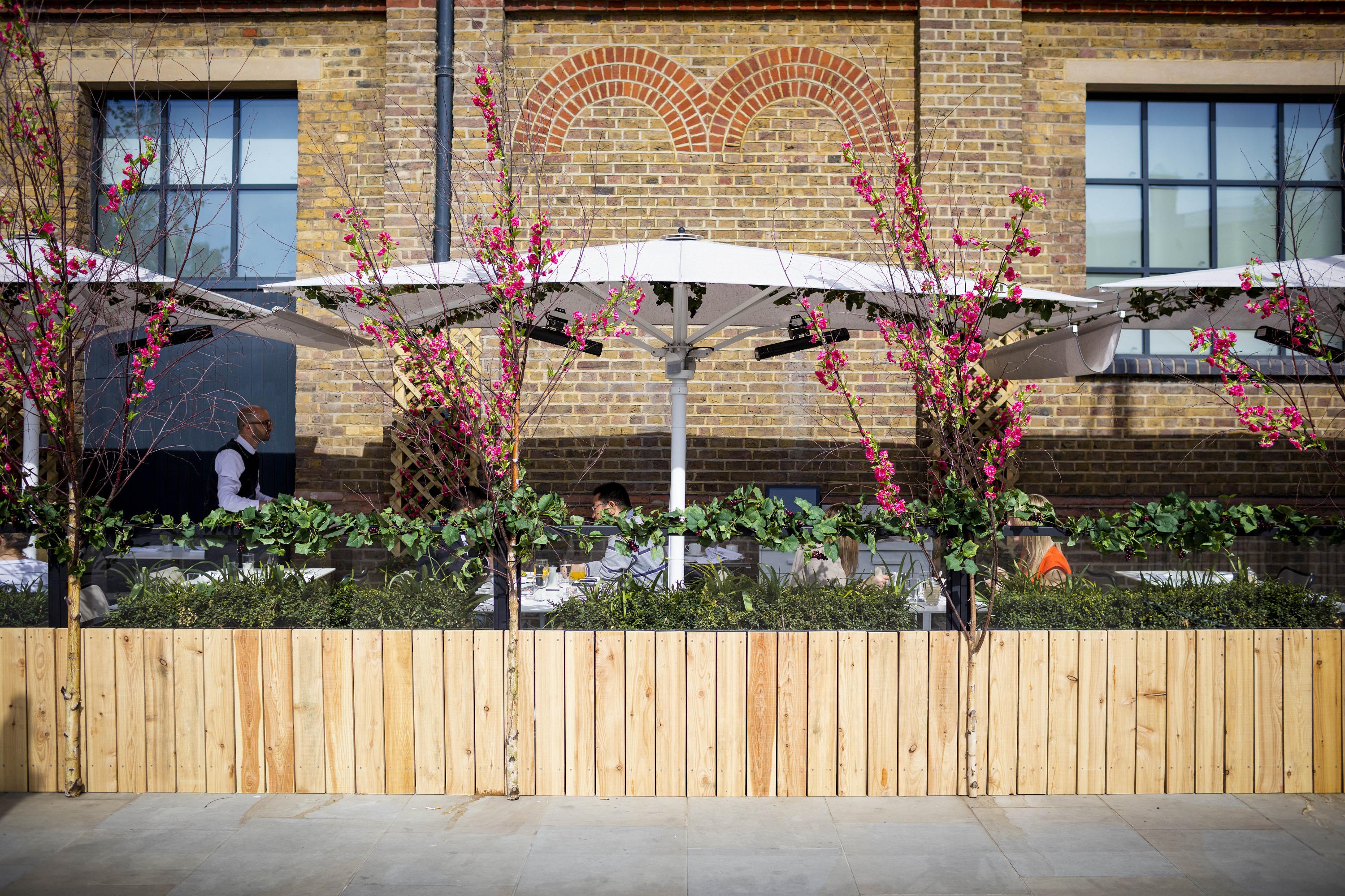 Charming outdoor event space at German Gymnasium with stylish umbrellas for gatherings.