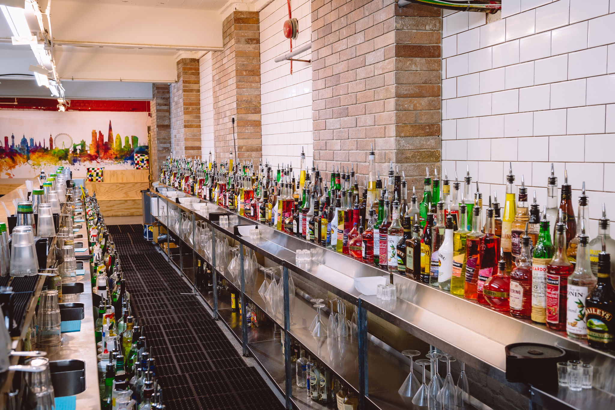 Main Room at London Bartender School with a vibrant bar setup for cocktail events.