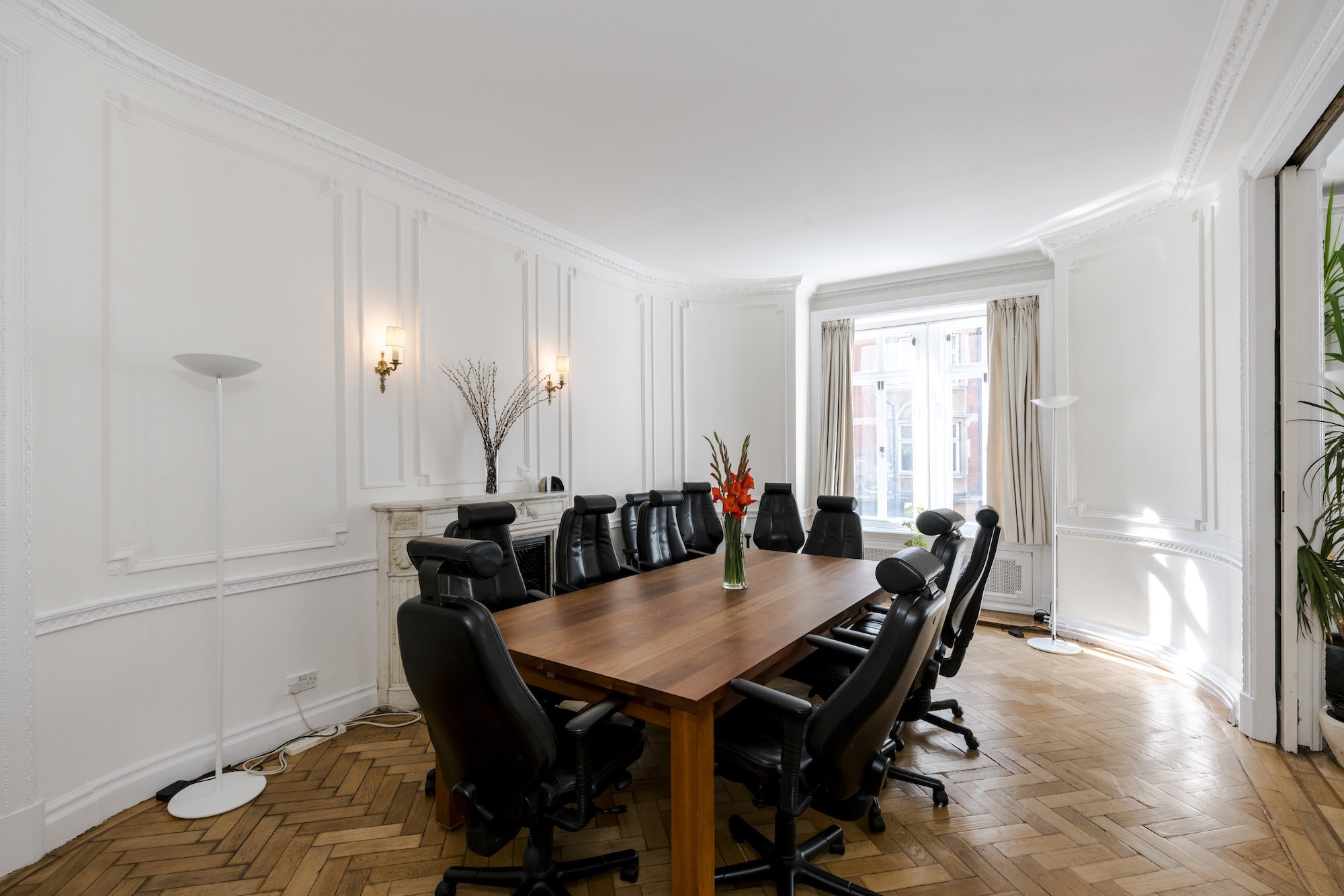 Boutique boardroom with large wooden table, ideal for meetings and brainstorming sessions.