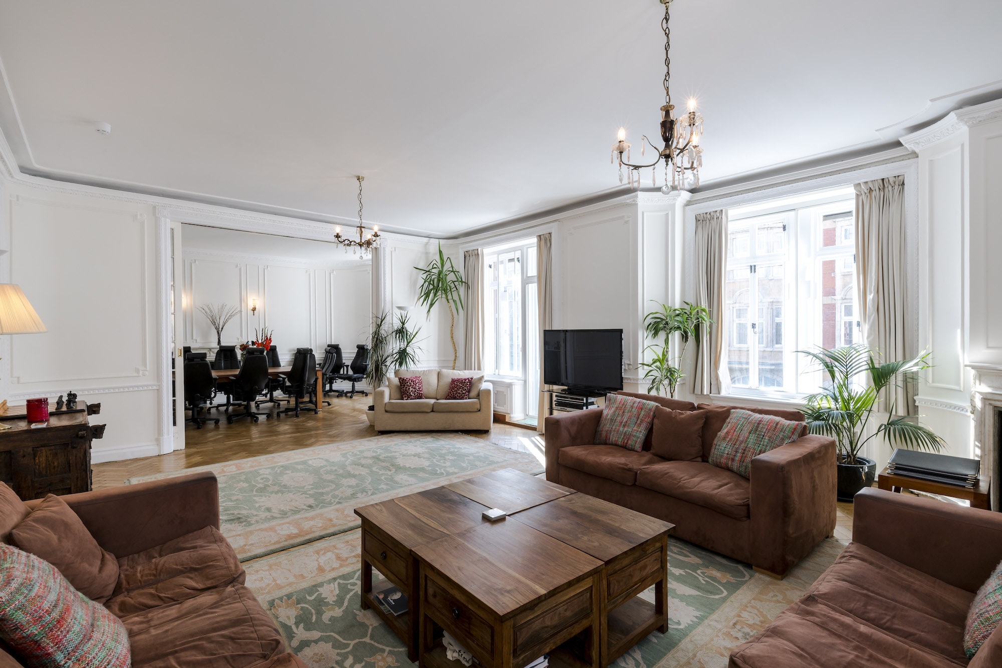 Elegant boutique boardroom with natural light, ideal for meetings and networking events.