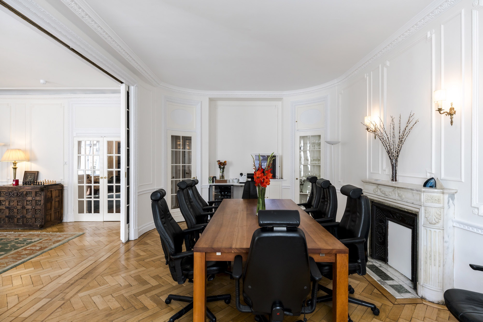 Boutique boardroom with wooden table and ergonomic chairs for productive meetings.