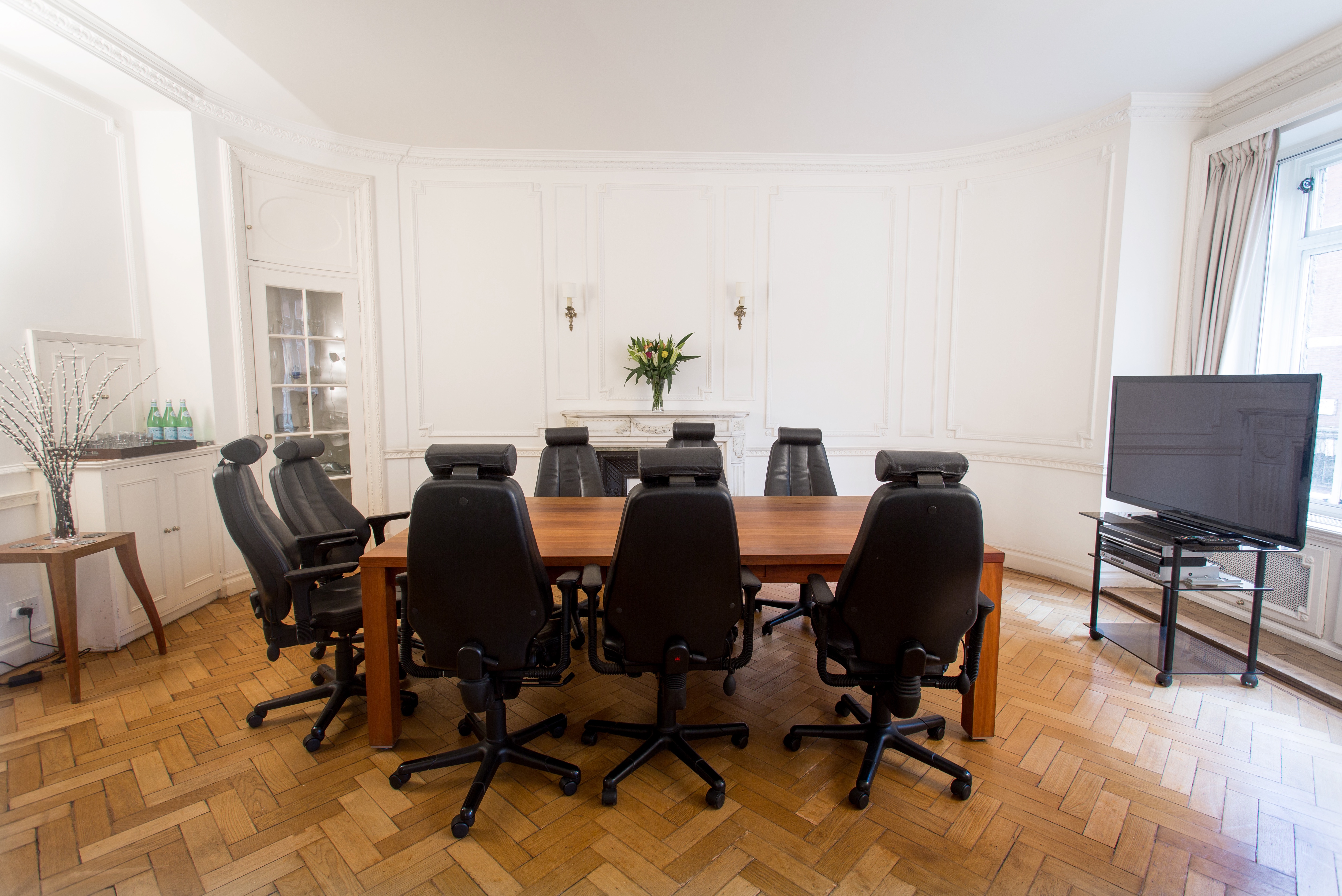 Modern conference room with dark chairs, ideal for meetings and presentations.