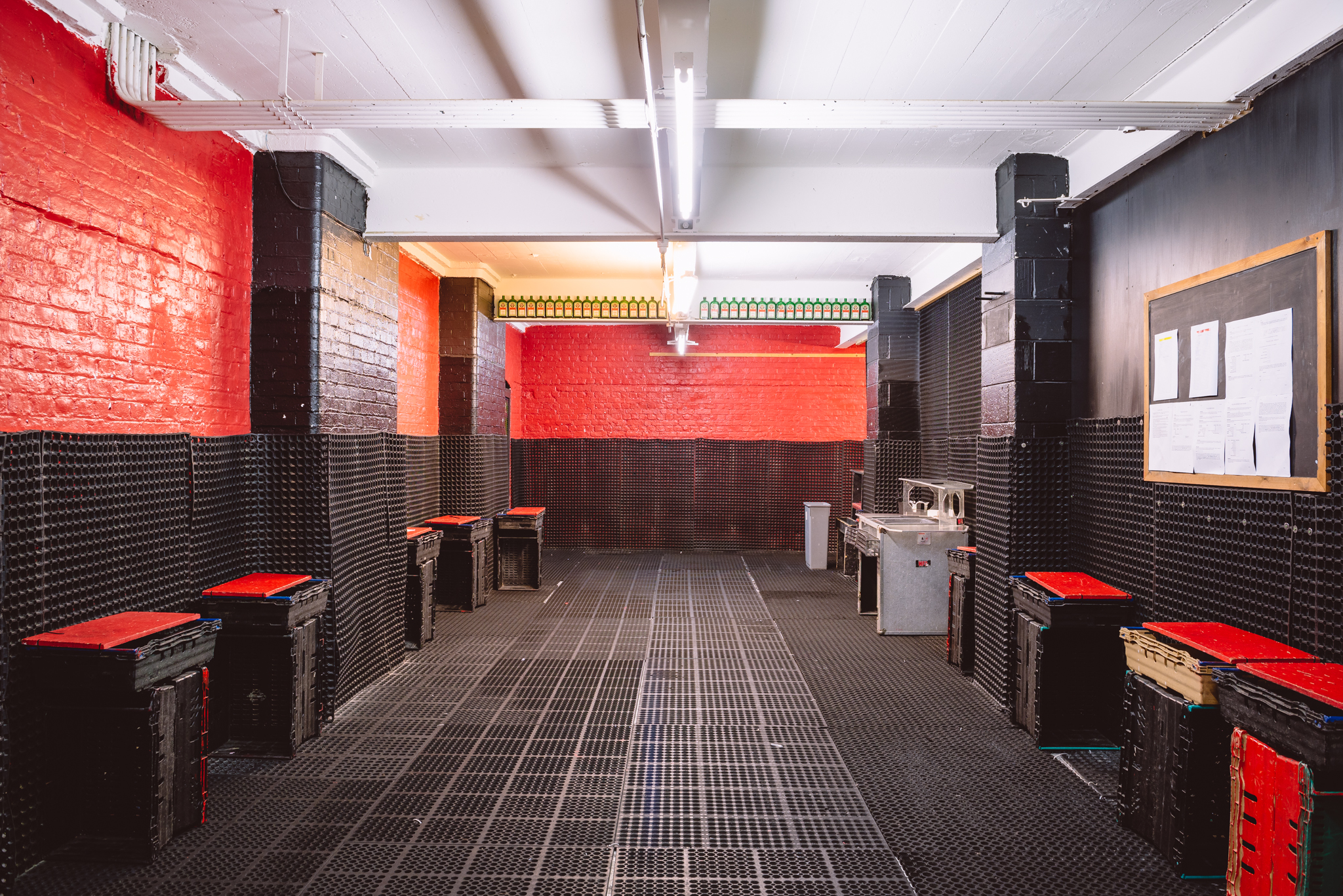 Main Room at London Bartender School: industrial space with red walls for events.