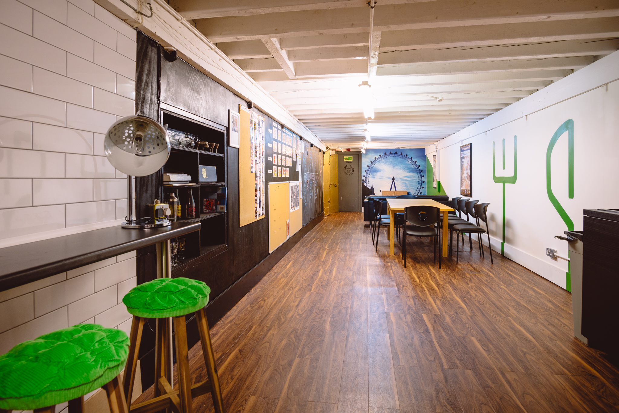 Main Room at London Bartender School with vibrant wall art for events and networking.