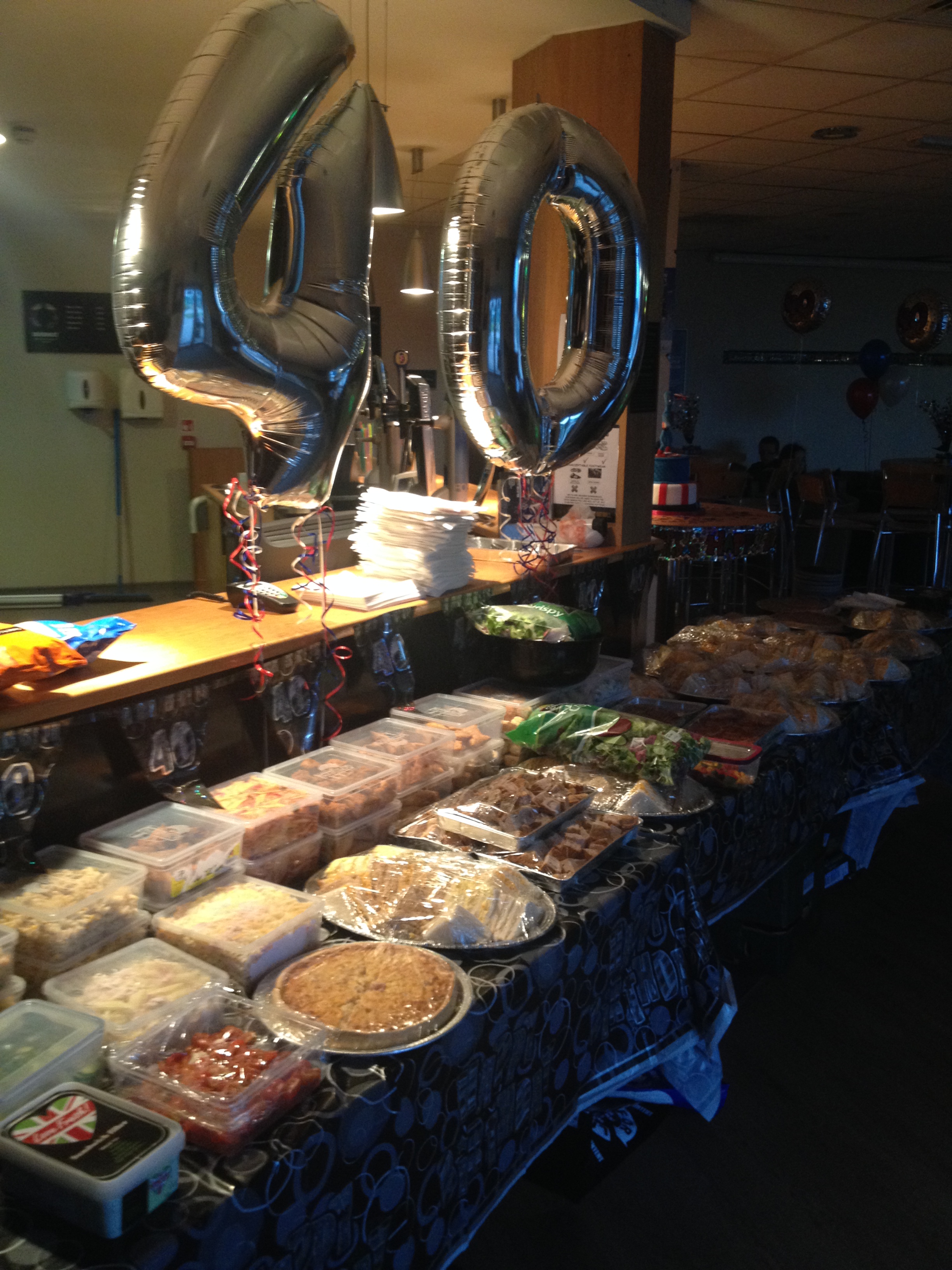 Buffet setup with silver balloons in PlayFootball York for a festive celebration event.