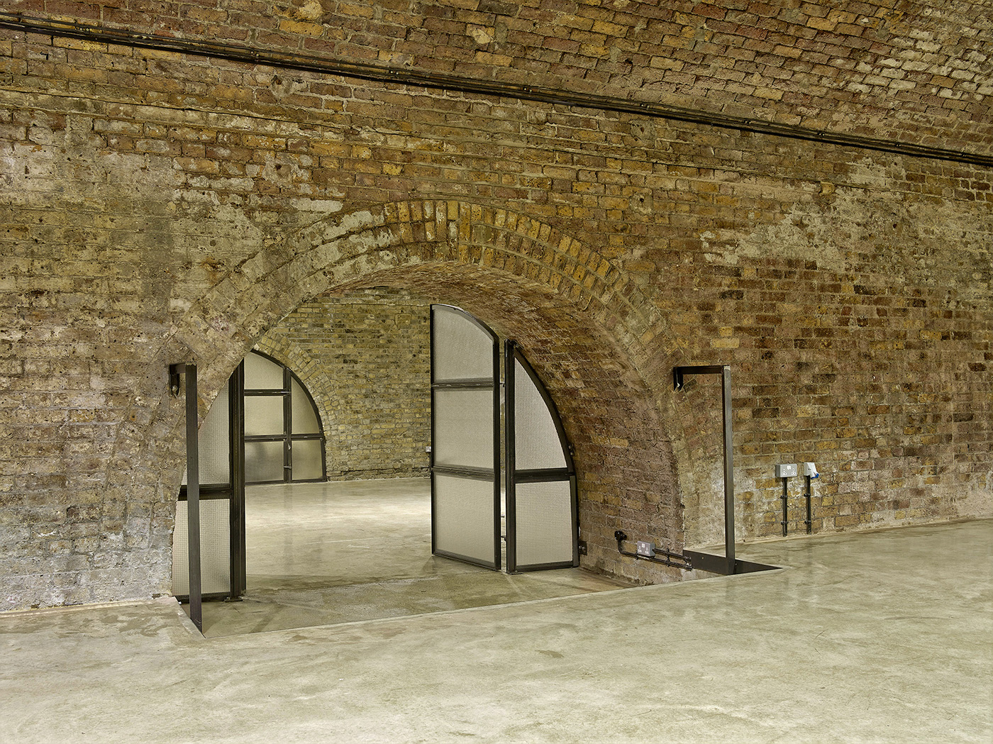 Versatile event space with exposed brick walls, ideal for gatherings and meetings.