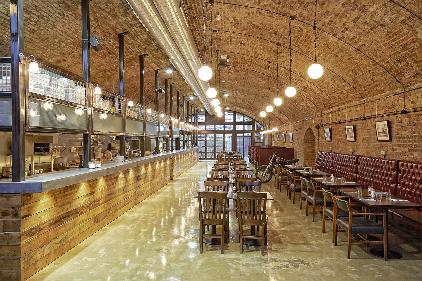 Elegant restaurant with arched brick ceiling, perfect for events and private dining.