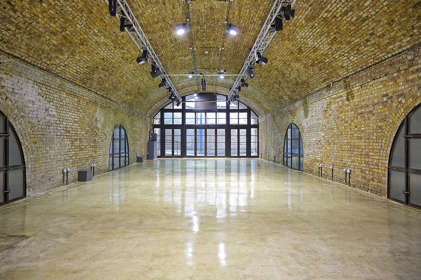 Spacious industrial venue with exposed brick, perfect for events and gatherings.