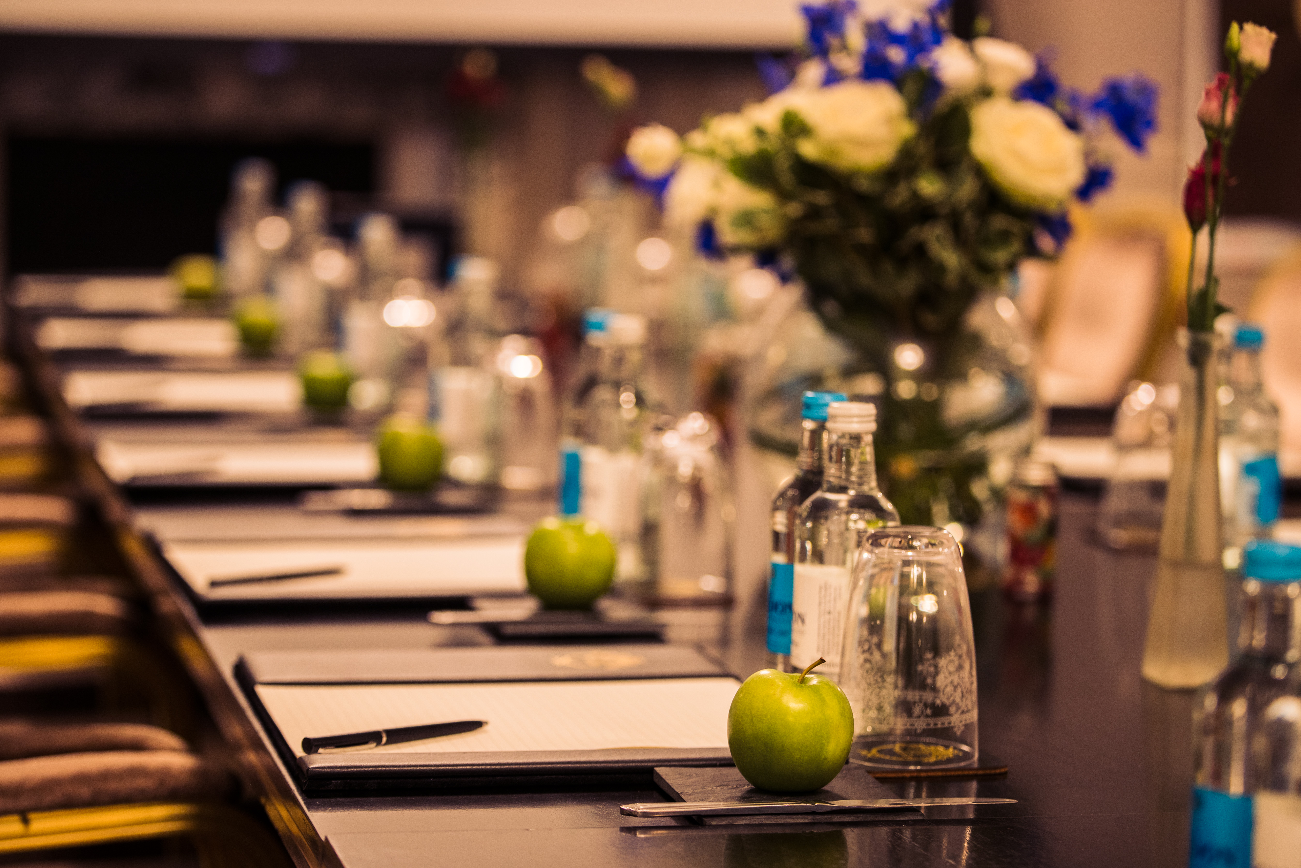 Aldwych Suite meeting setup with elegant floral centerpiece at The Waldorf Hilton, London.