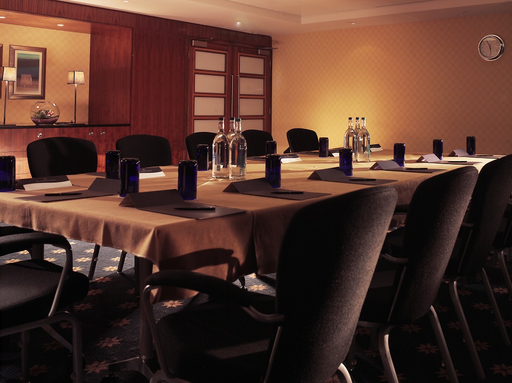 Mackenzie in a stylish meeting room at The Waldorf Hilton, London, perfect for conferences.