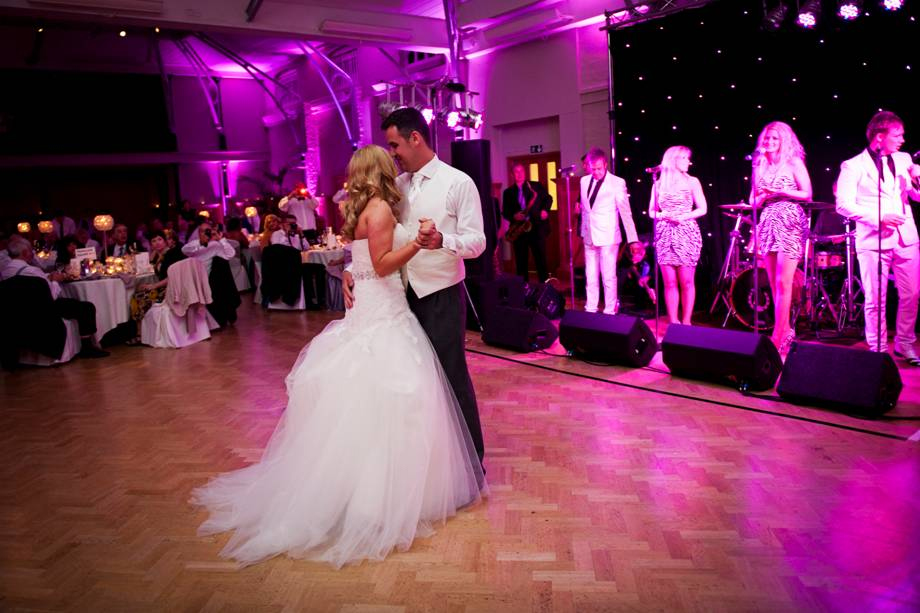 Wedding reception at HAC with couple's first dance under romantic lighting.