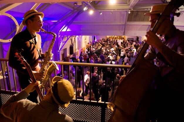 Live musicians in stylish attire at Prince Consort Rooms, HAC event atmosphere.