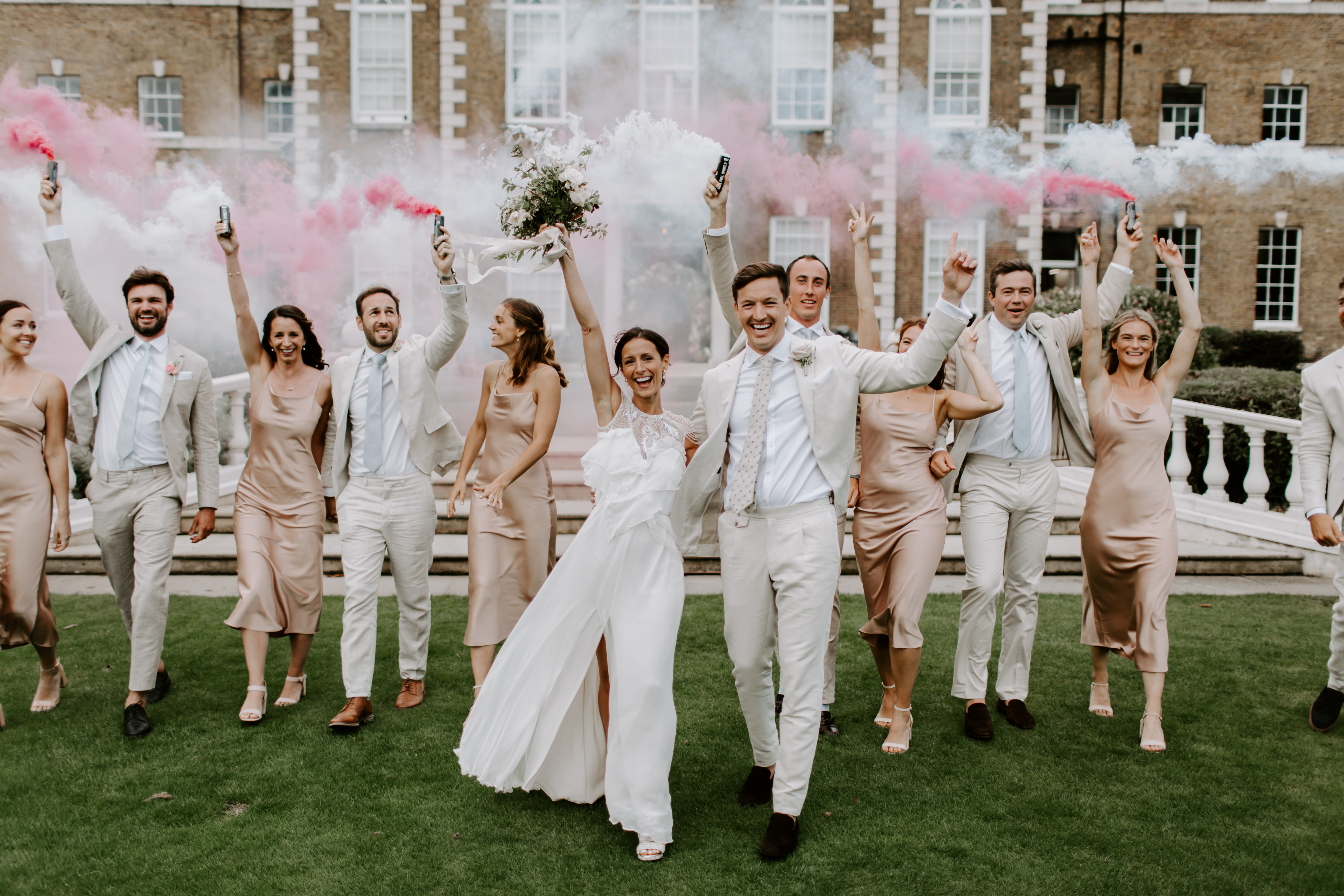 Vibrant wedding celebration at HAC Artillery Garden with smoke bombs and elegant attire.
