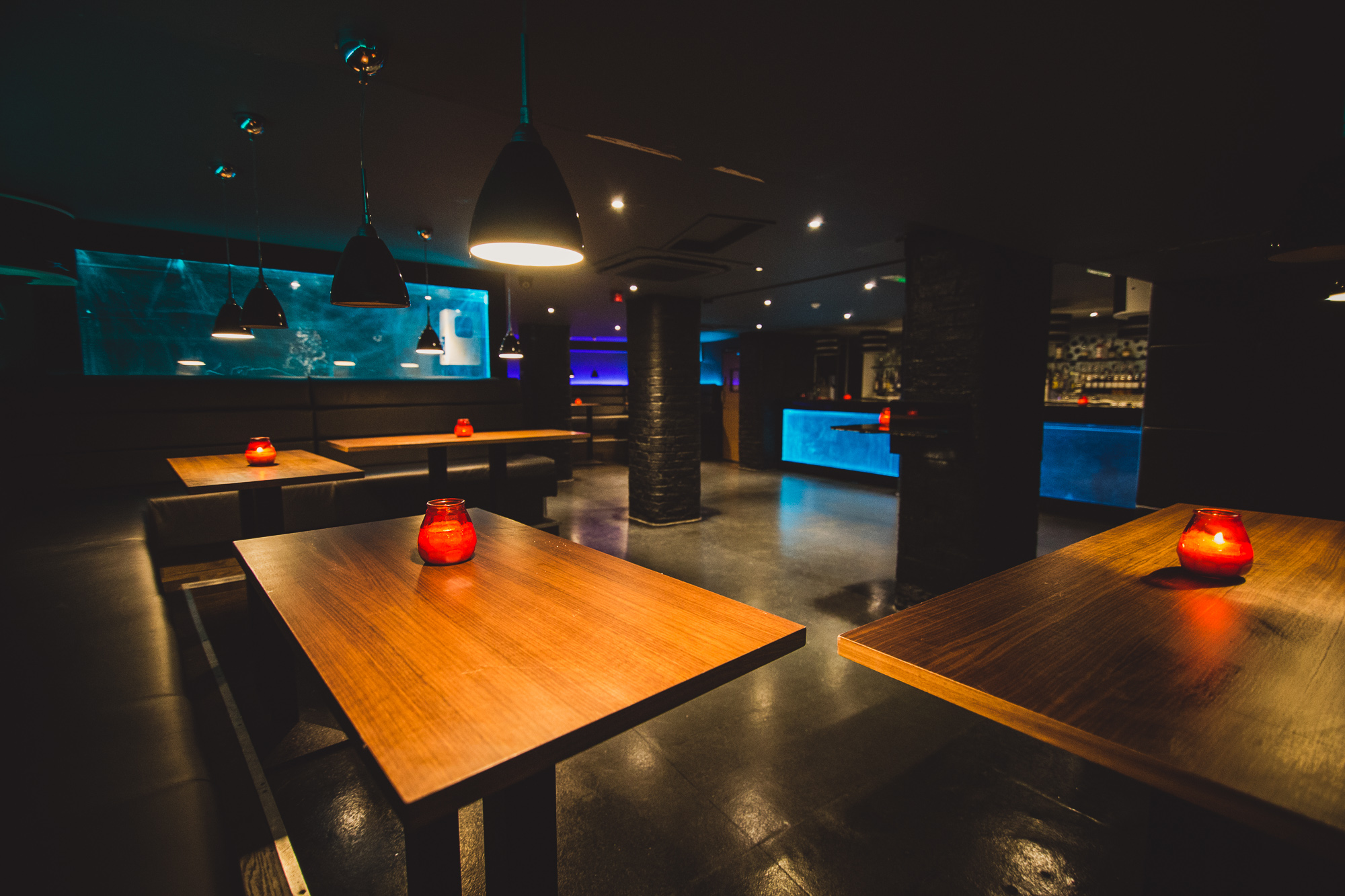 Modern event space in Walrus with wooden tables and ambient lighting for receptions.