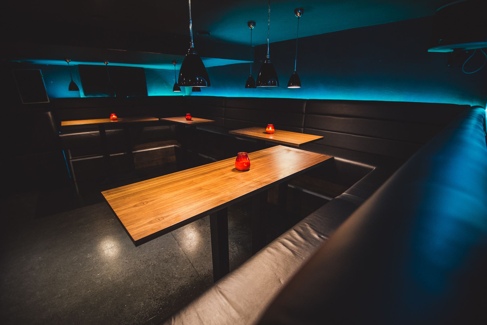 Modern event space in Walrus with cozy seating and blue lighting for intimate gatherings.