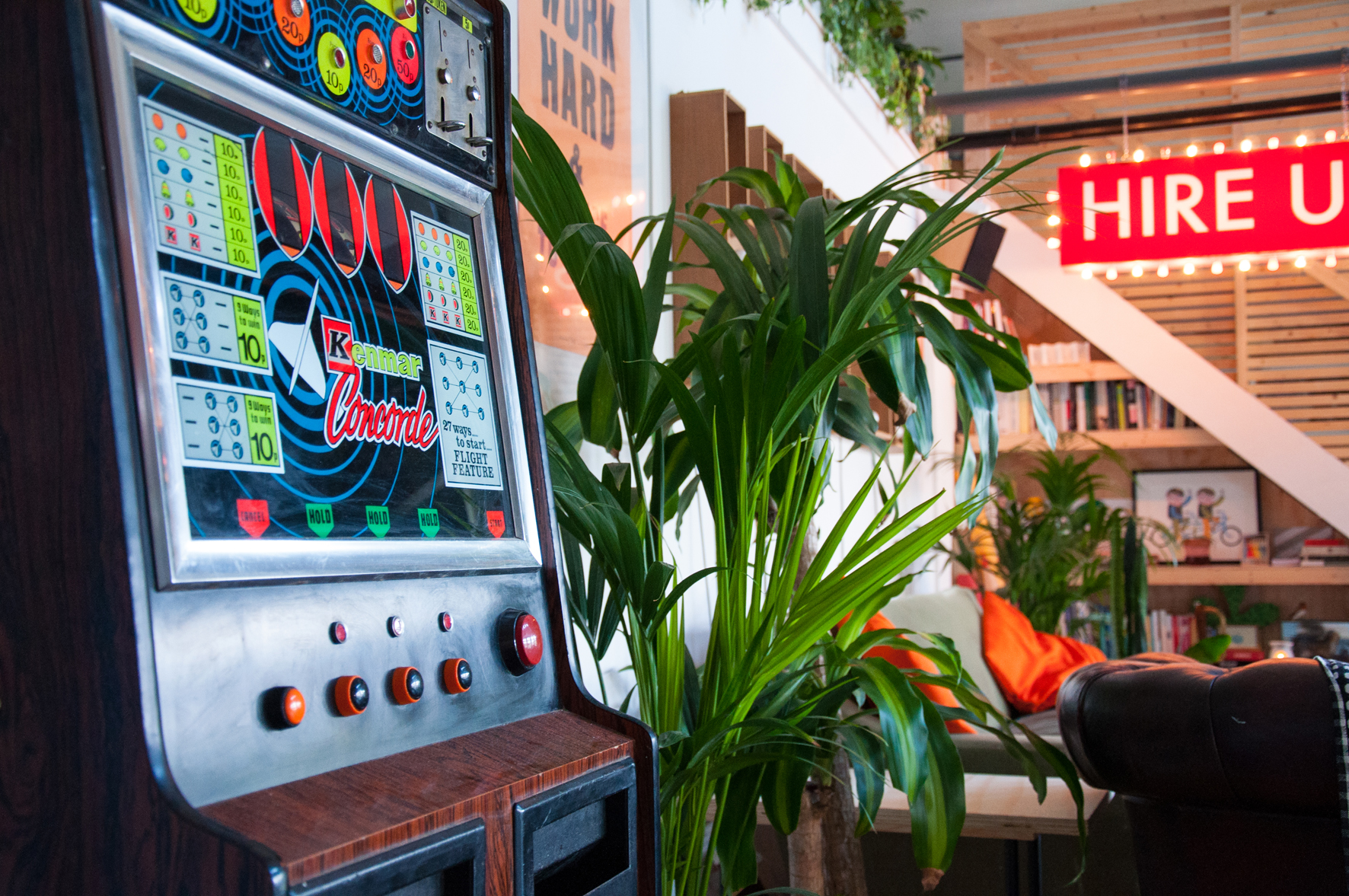 Vintage slot machine in vibrant Lord Whitney Studio for playful event decor.