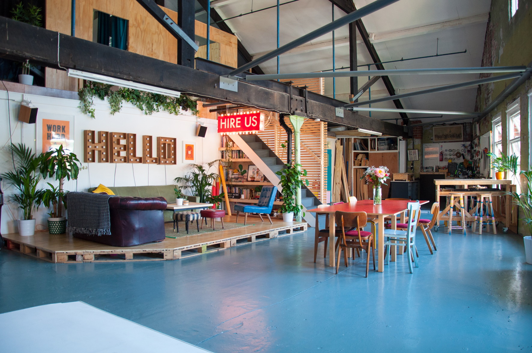 Versatile event space in Lord Whitney Studio with vibrant decor and greenery for creative workshops.