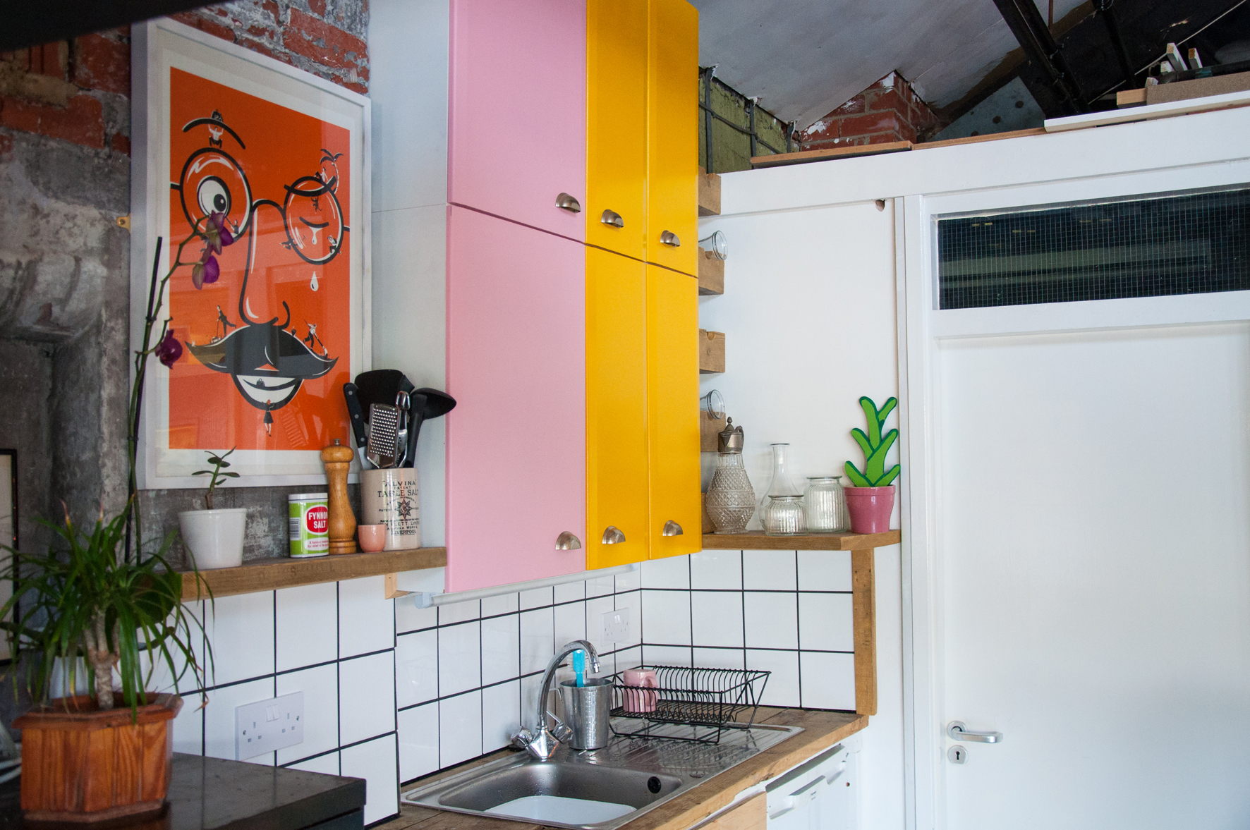 Vibrant kitchen venue with colorful cabinetry for casual meetings and team-building events.