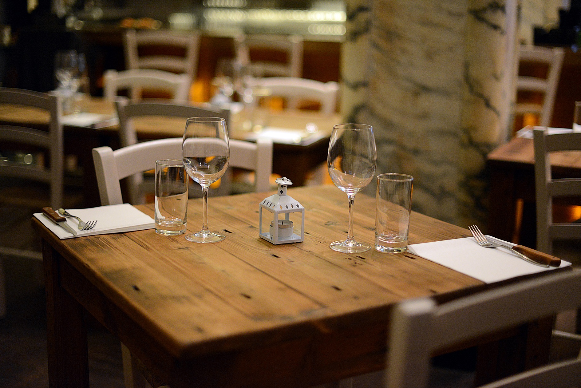 Chandelier Room dining table, rustic charm for intimate gatherings and business dinners.