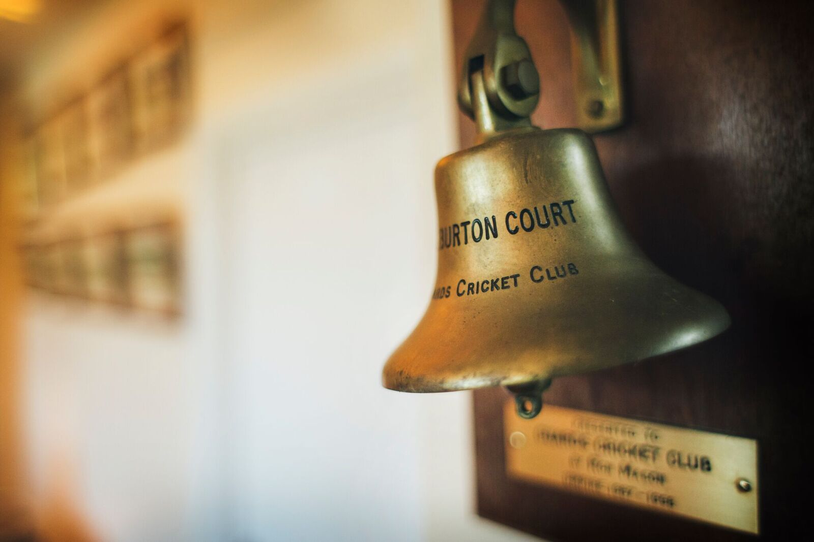 Vintage bell on wooden plaque at Burton Court, Royal Hospital Chelsea, ideal for events.