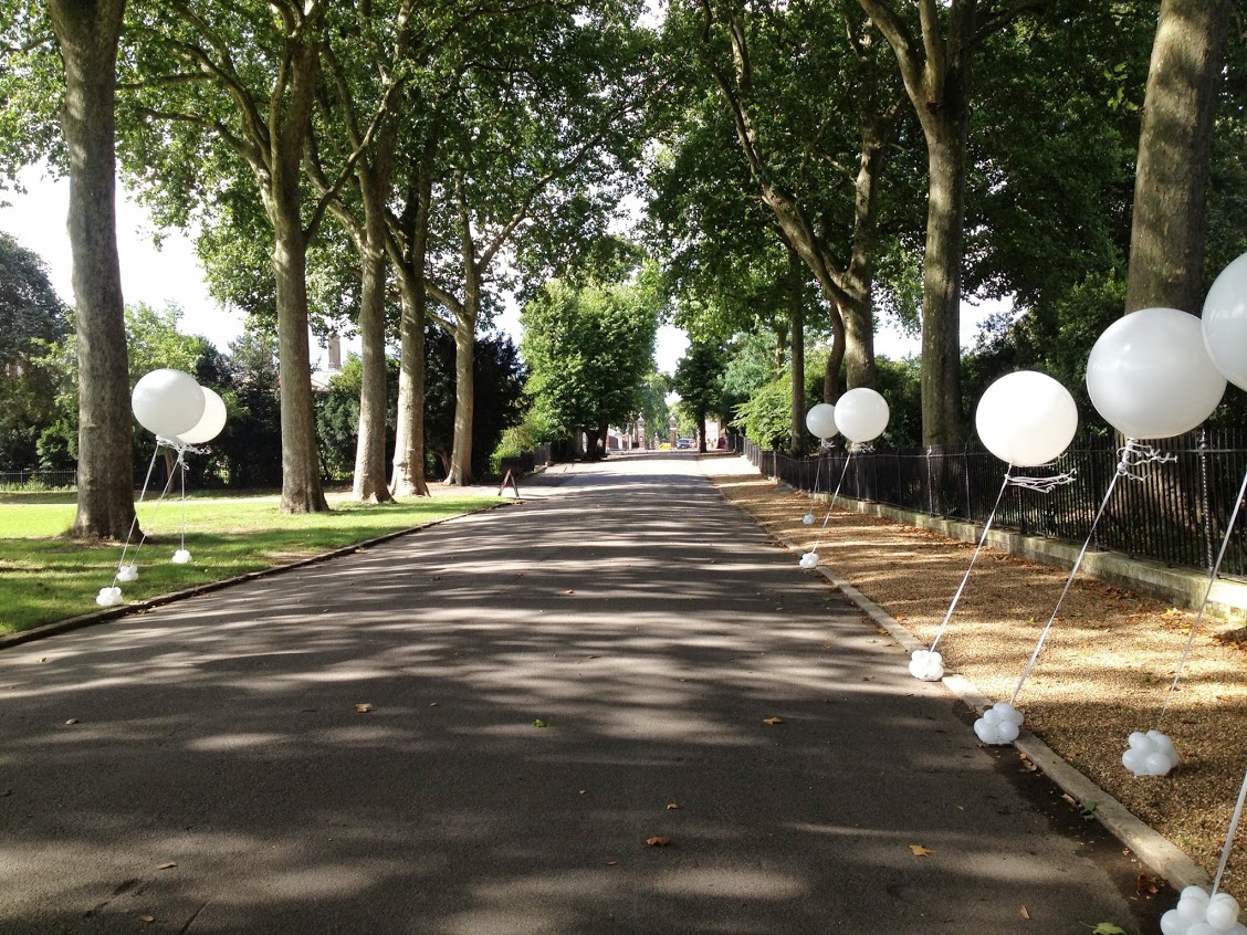 Ranelagh Gardens pathway with white balloons, ideal for weddings and outdoor events.