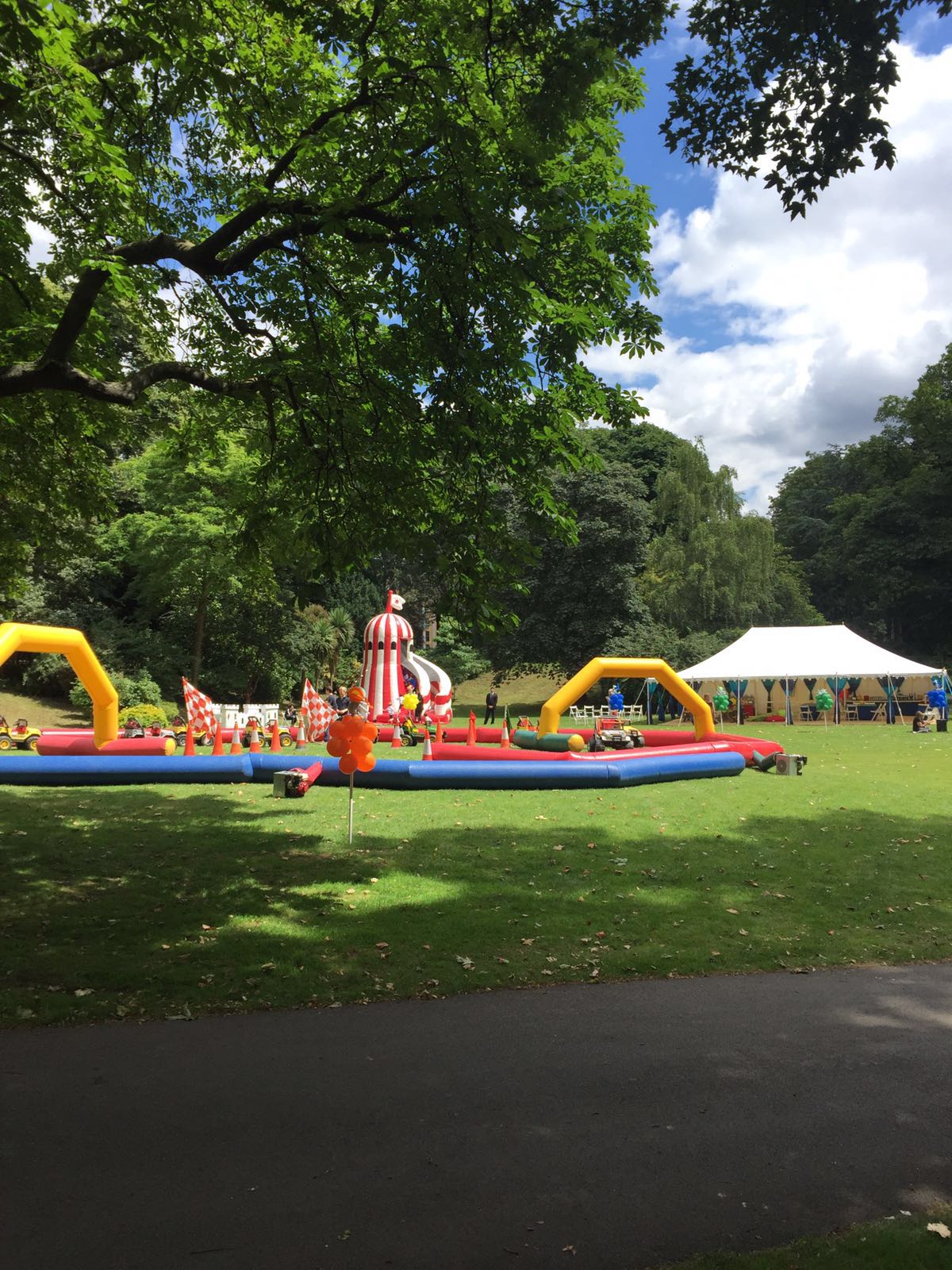 Ranelagh Gardens event with inflatable play area and spacious tent for family-friendly gatherings.