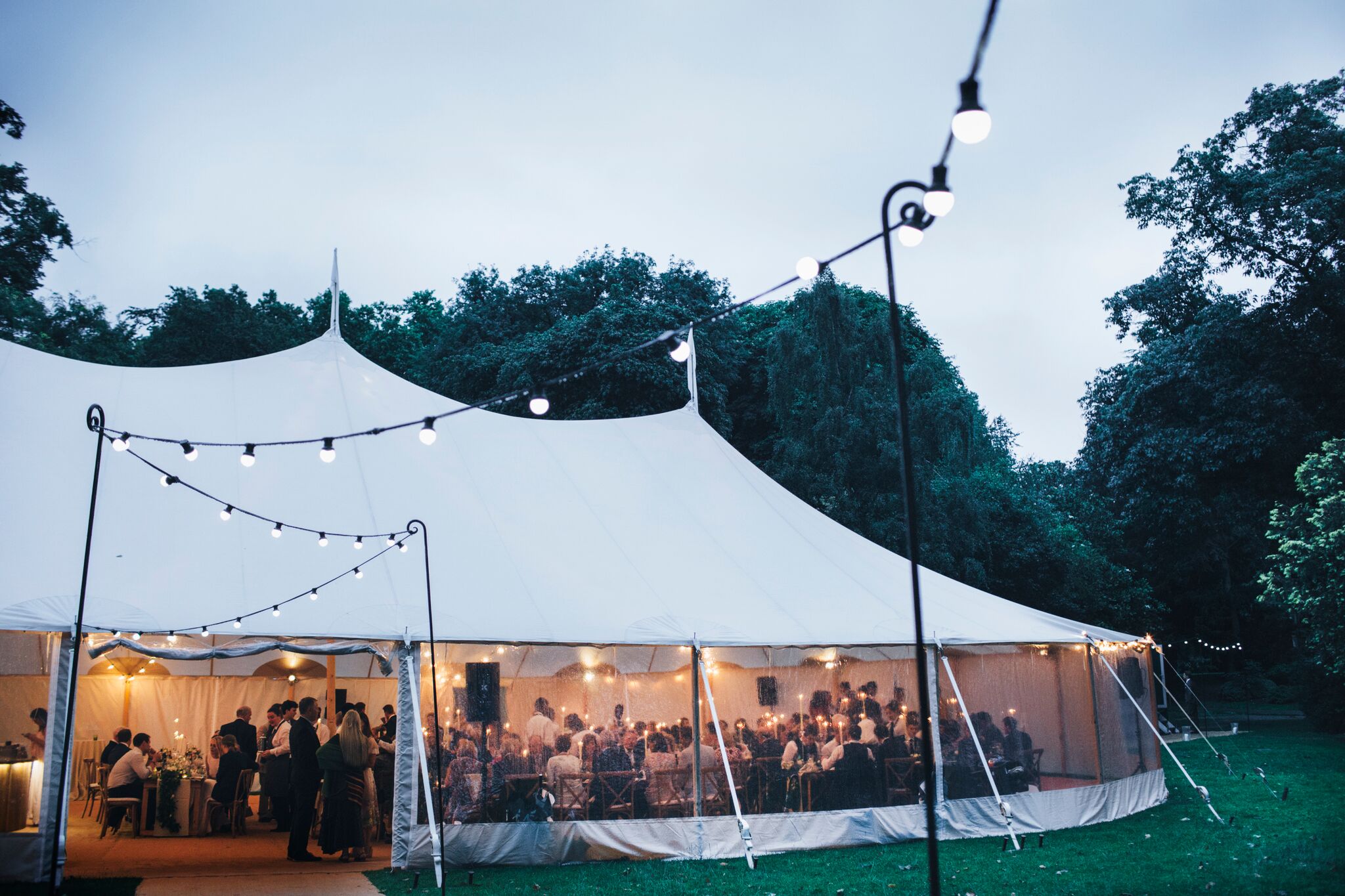 Outdoor event at Ranelagh Gardens, featuring a large tent and string lights for celebrations.