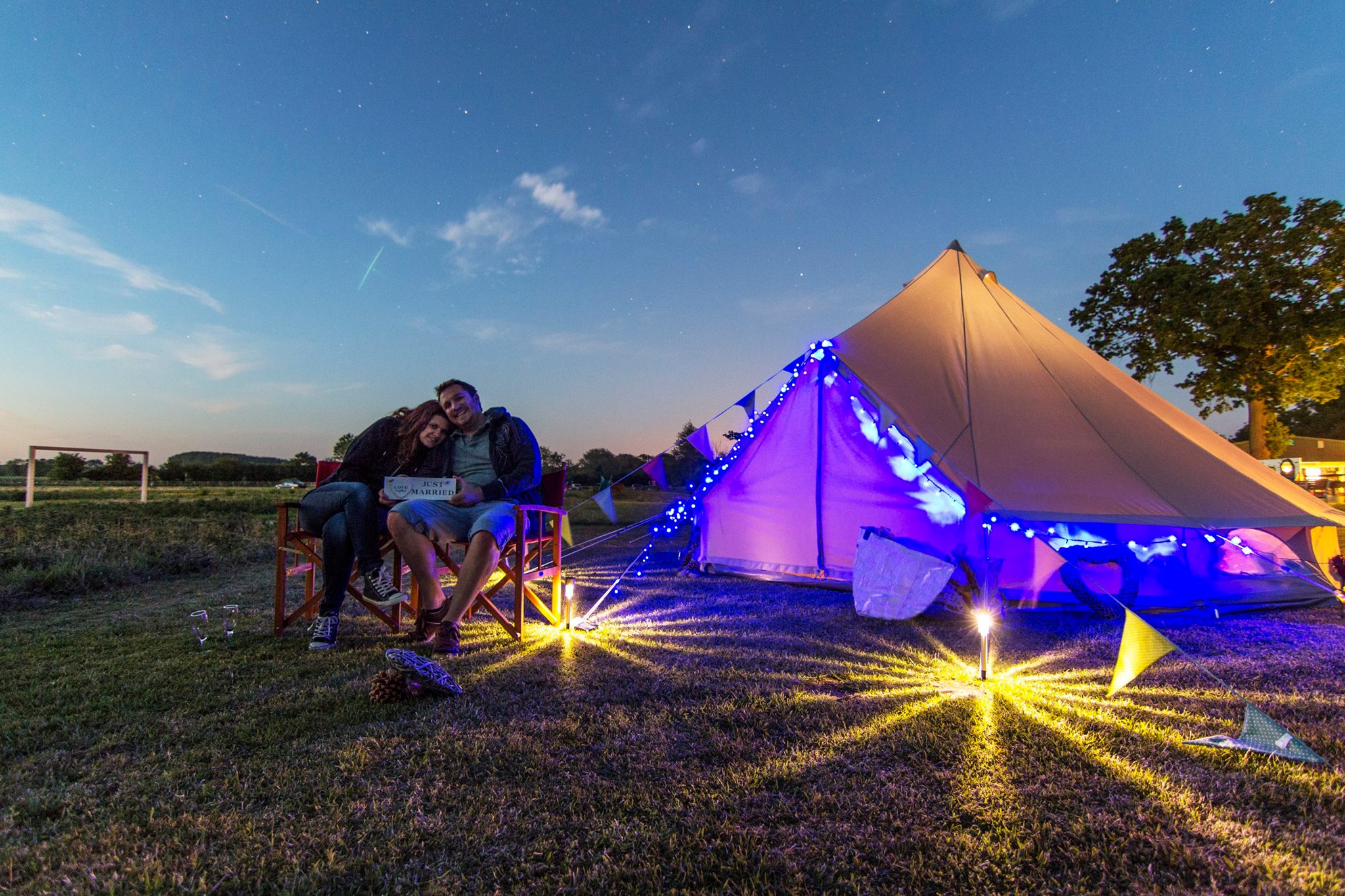 Cozy glamping tent with ambient lighting for team-building retreats in Camping Meadow.
