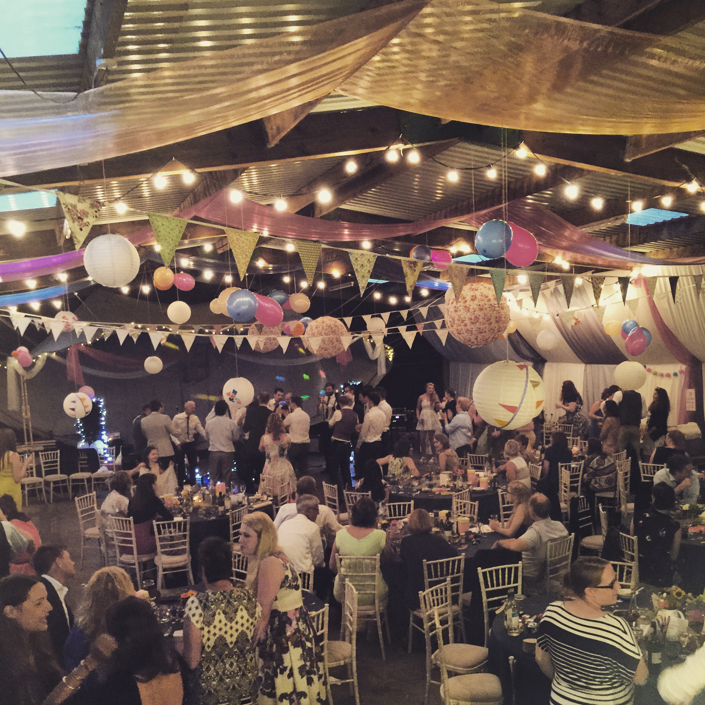 Vibrant Camping Meadow event with colorful decor, lively gathering, and dance floor.