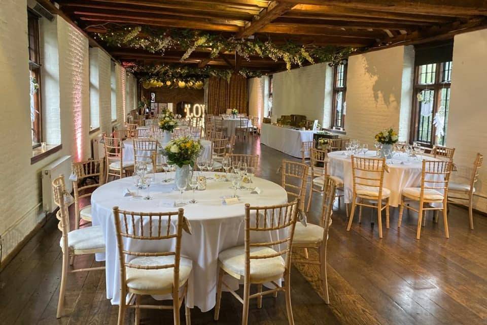 Tudor Barn Eltham event space with elegant tables, ideal for weddings and gatherings.