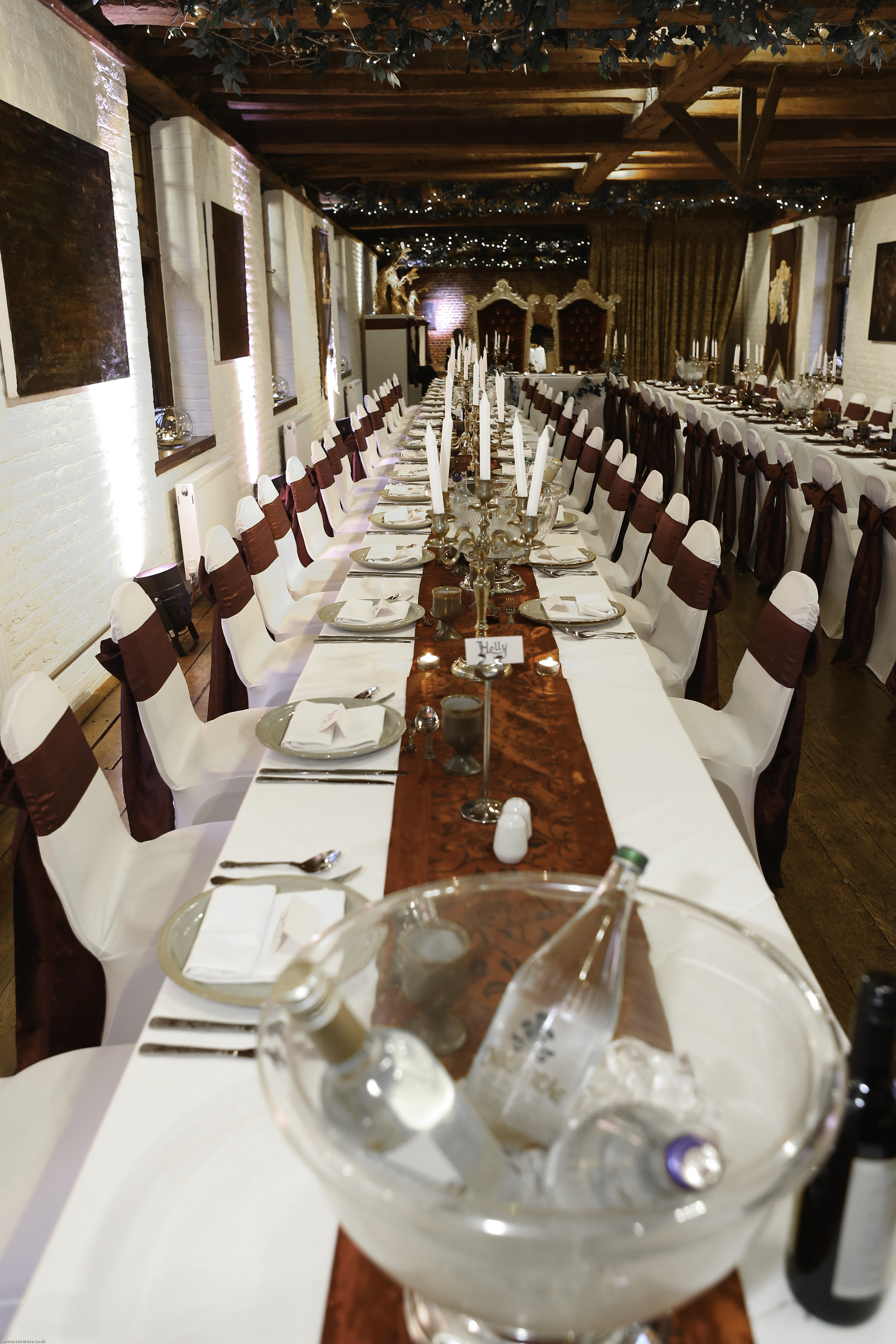 Elegant banquet setup at Tudor Barn Eltham with white linens and polished silverware.