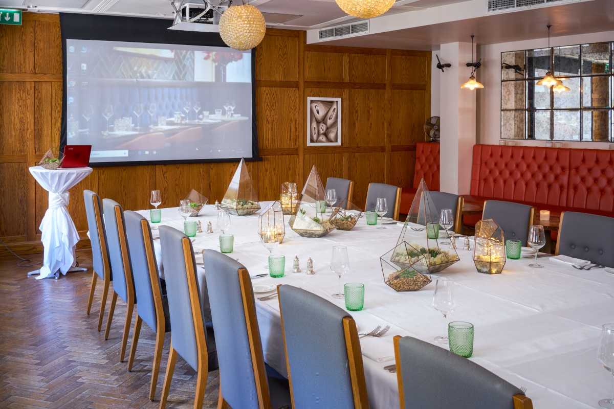 Sir Roger Moore Room in Hush Mayfair set for corporate dinner or meeting, elegant decor.