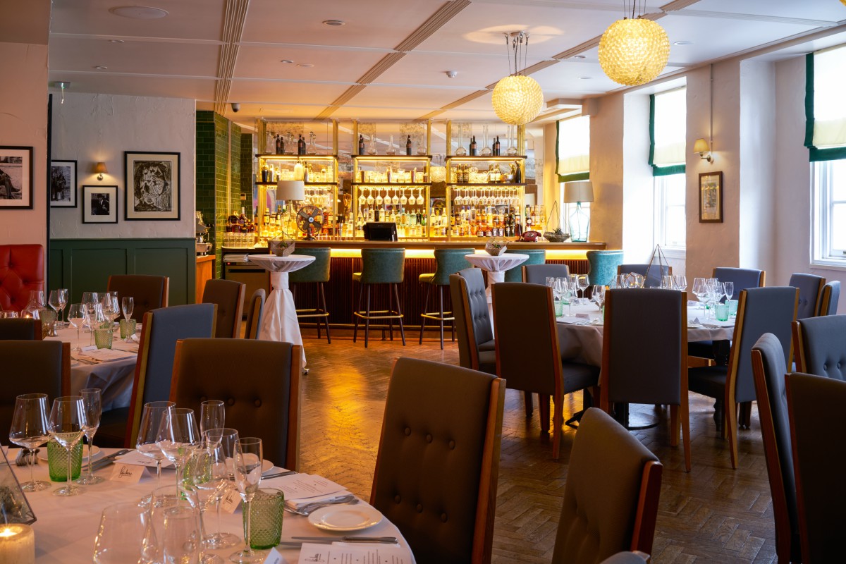 Elegant dining setup in The Sir Roger Moore Room, perfect for corporate events and intimate dinners.
