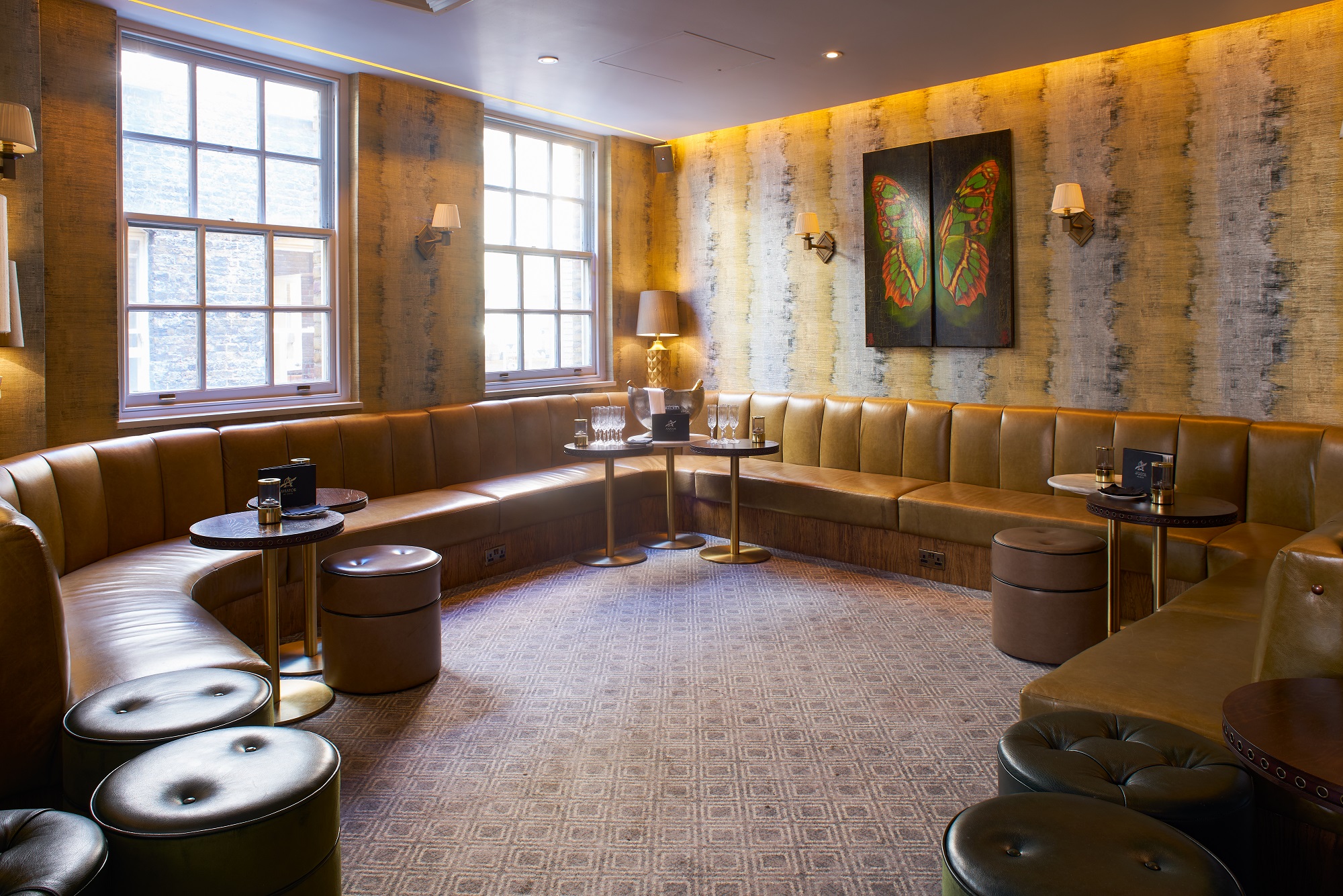 Stylish meeting space at Hush Mayfair with cozy leather banquette, ideal for networking events.