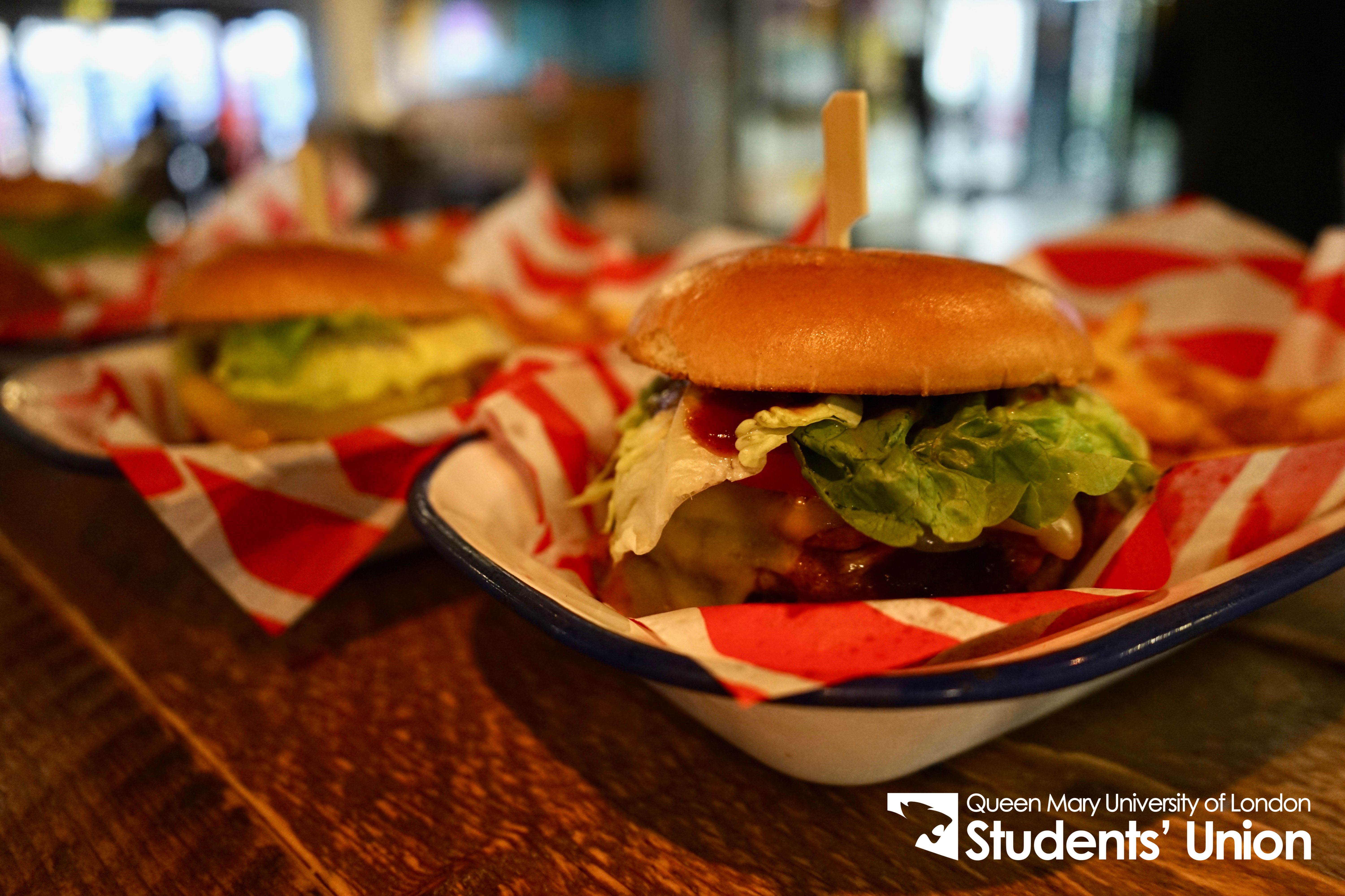 Gourmet burgers and fries in vibrant setup at Drapers Bar & Kitchen for networking events.