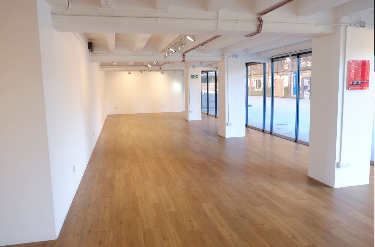 Versatile event space at gallery@oxo, featuring large windows and minimalist design.